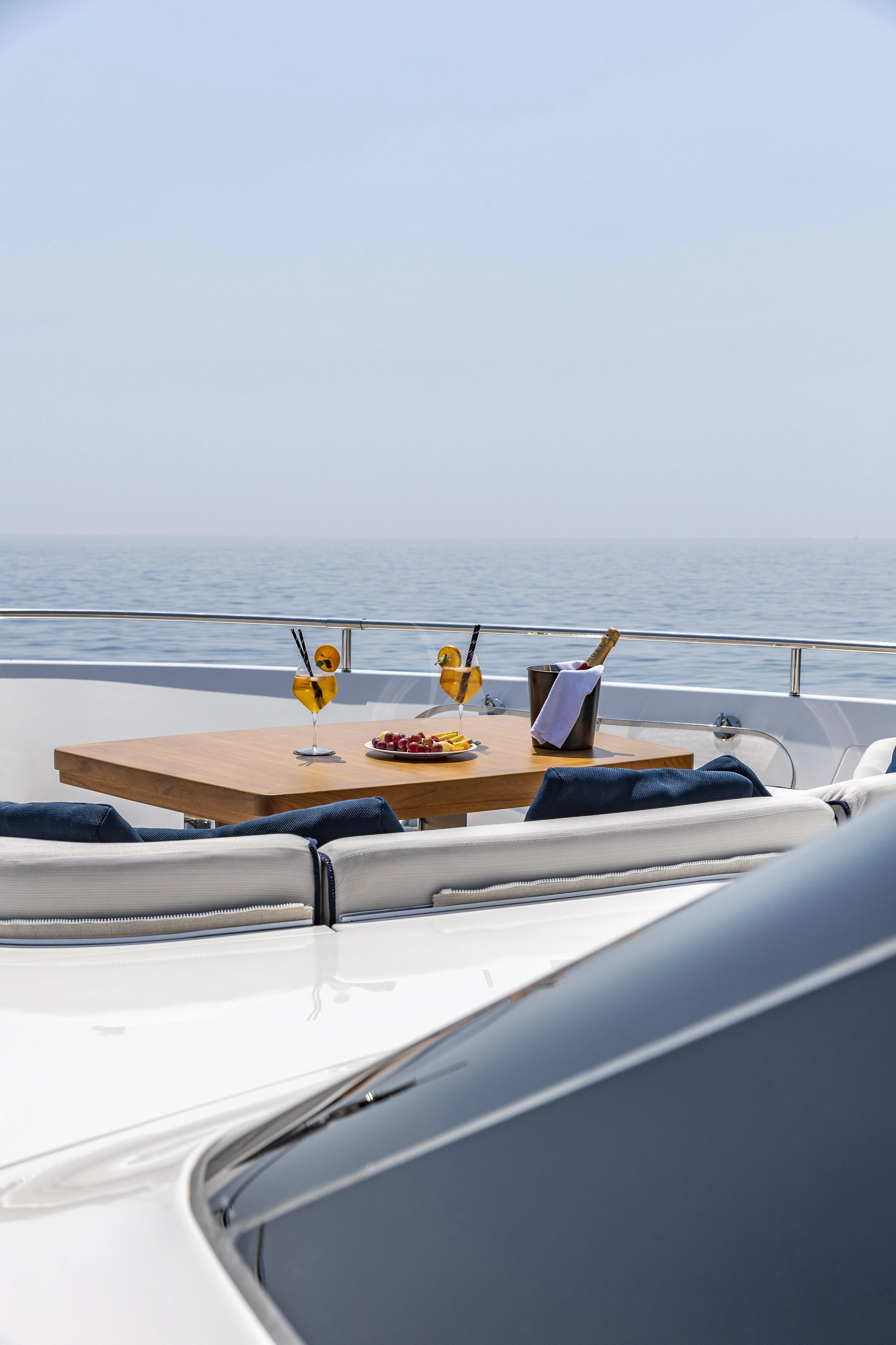 a table with glasses and a couple of glasses on it aboard AMAN Yacht for Sale