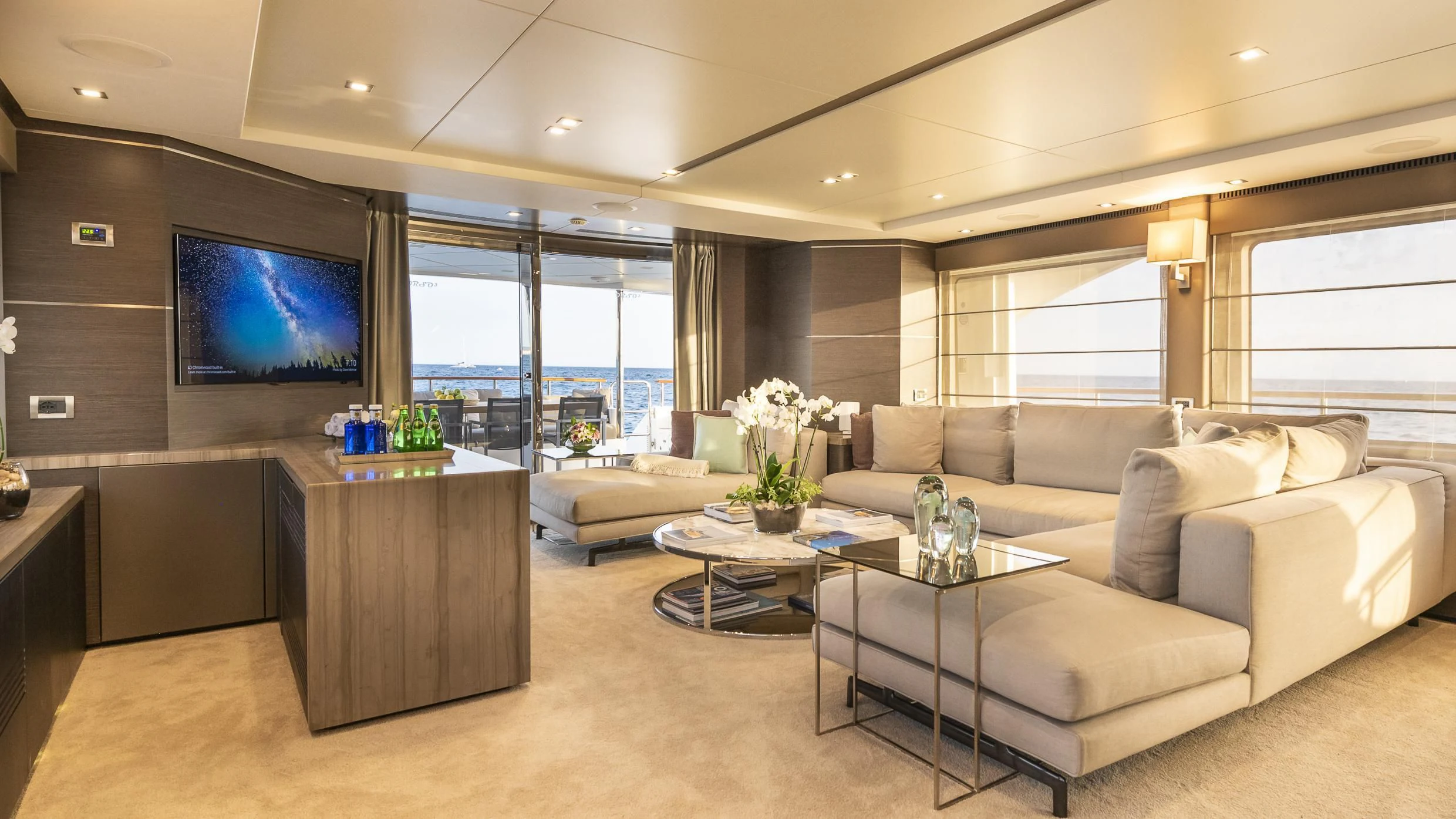 a living room with a large screen aboard ORSO 3 Yacht for Sale