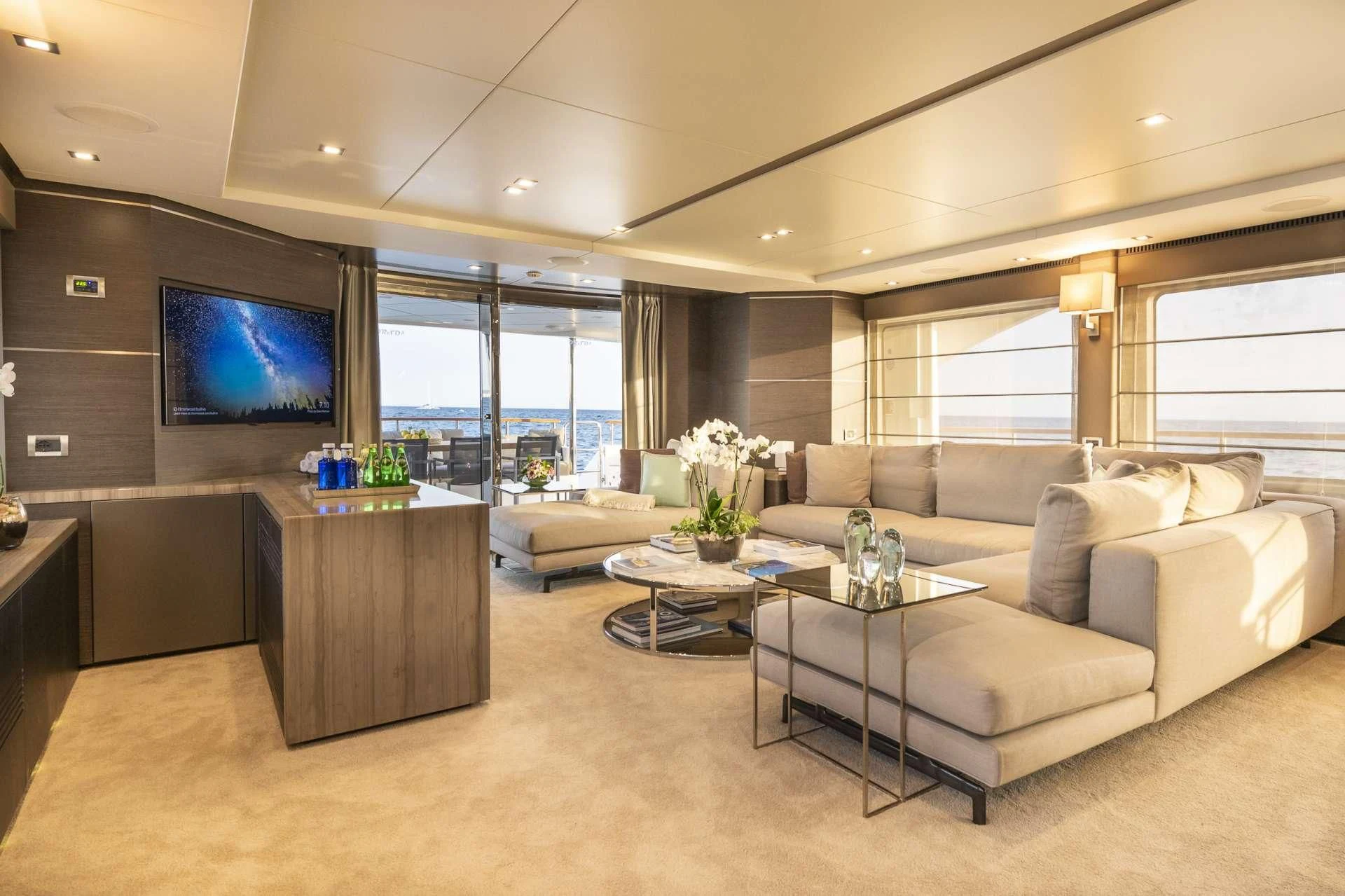 a living room with a large screen aboard ORSO 3 Yacht for Sale