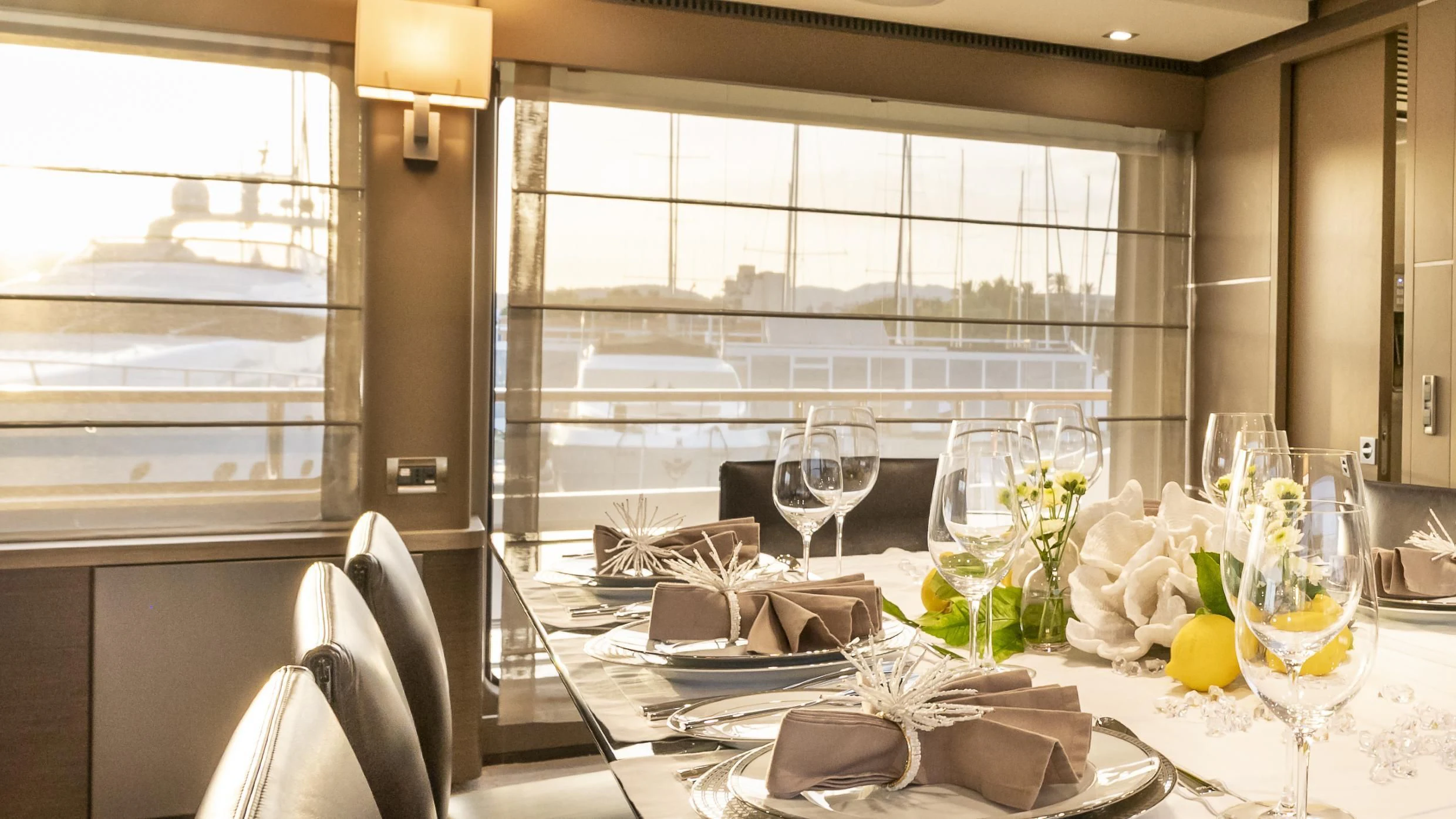 a table with wine glasses and flowers aboard ORSO 3 Yacht for Sale