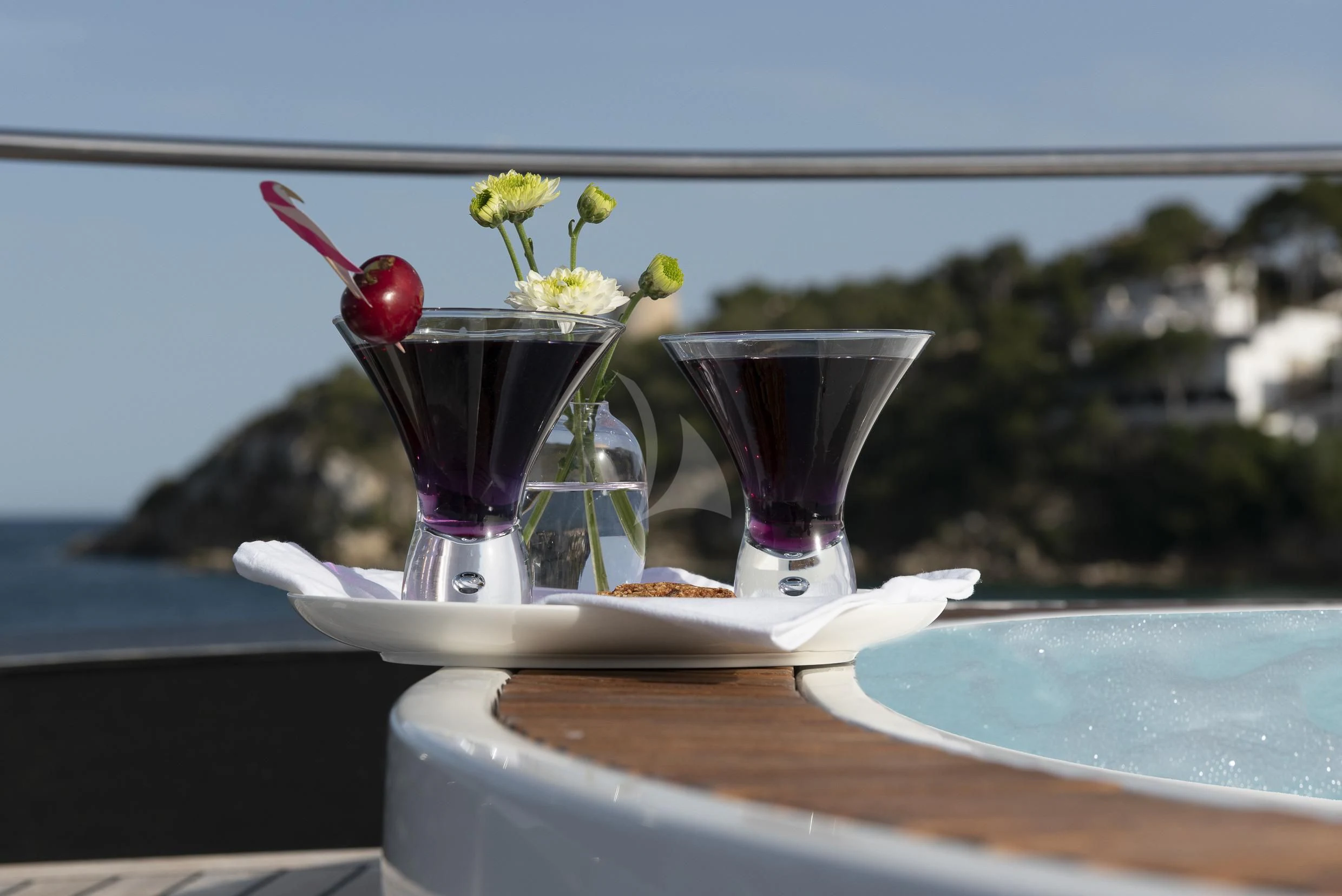 a couple of glasses with flowers on a table aboard ORSO 3 Yacht for Sale