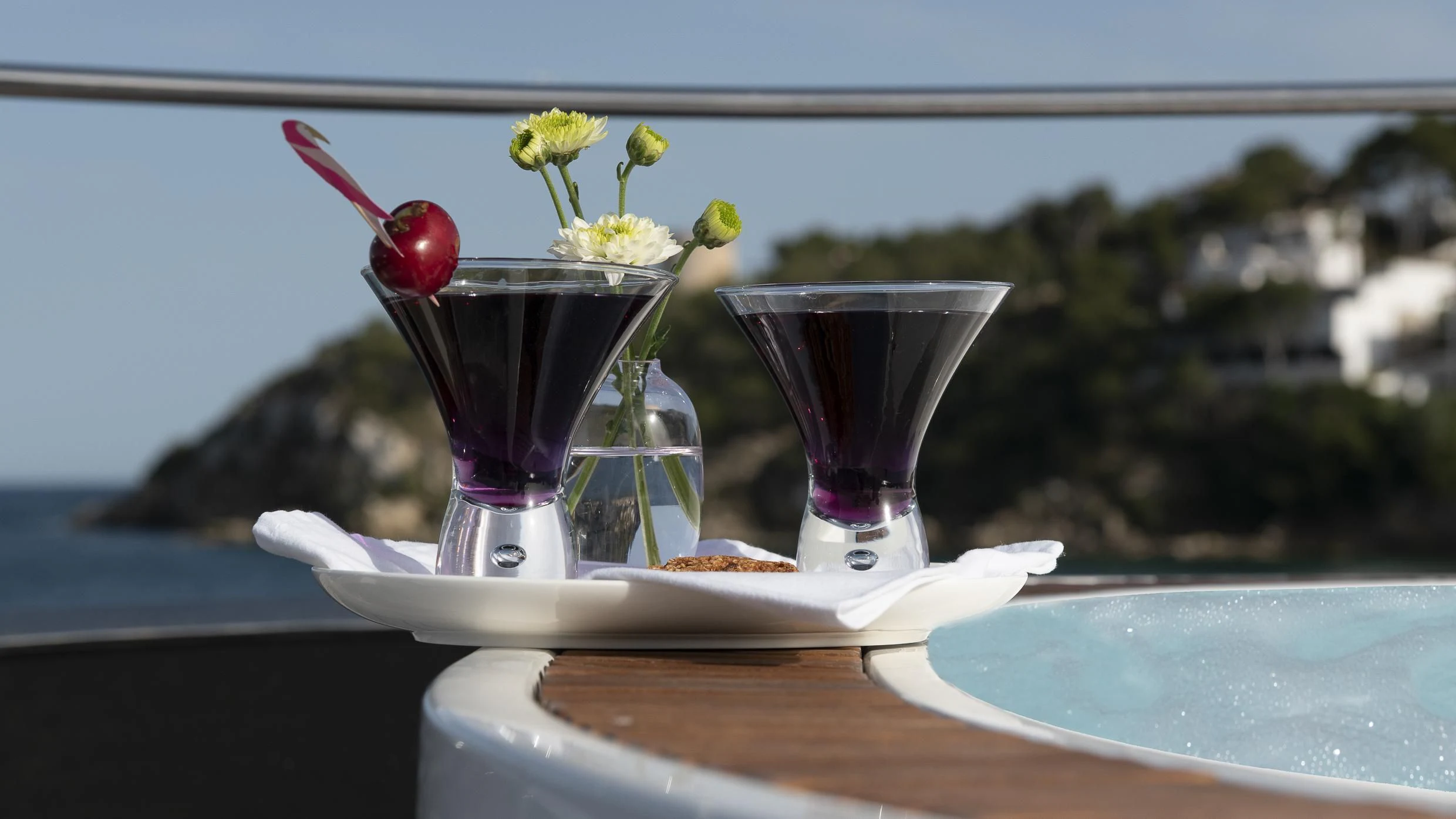 a glass with a drink and fruit on a table aboard ORSO 3 Yacht for Sale