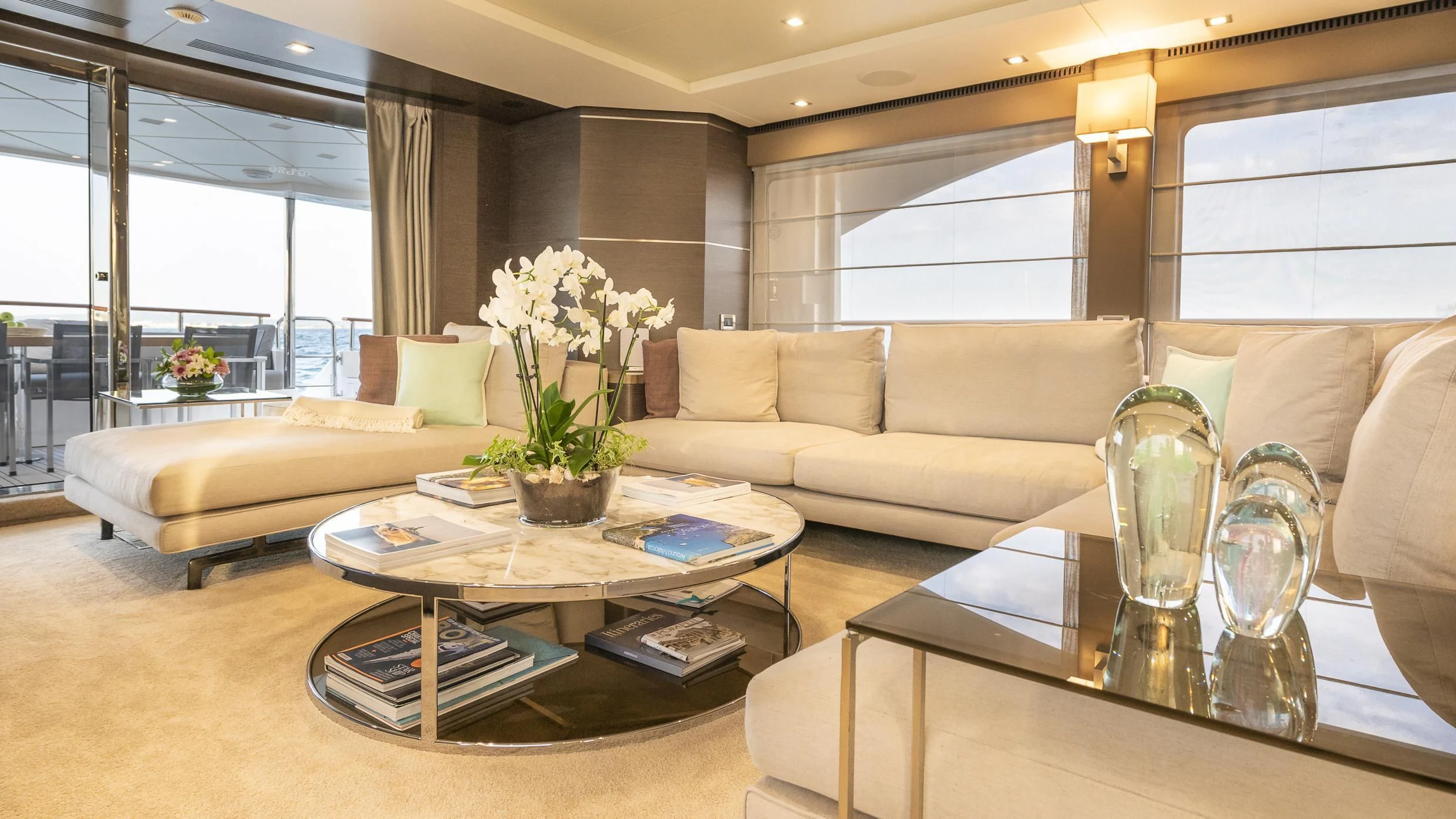 a living room with a glass coffee table and a couch aboard ORSO 3 Yacht for Sale
