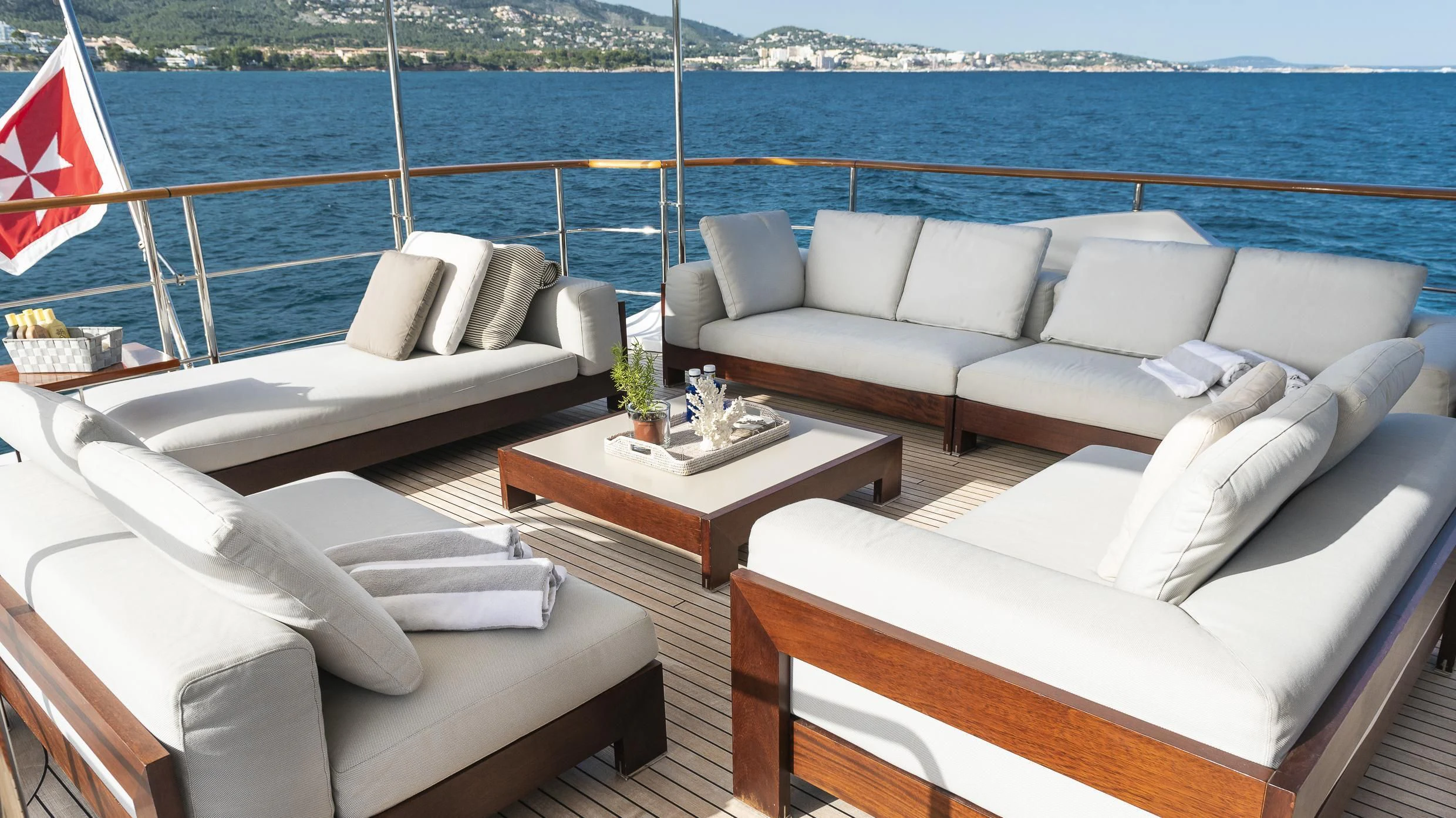 a room with couches and a flag aboard ORSO 3 Yacht for Sale