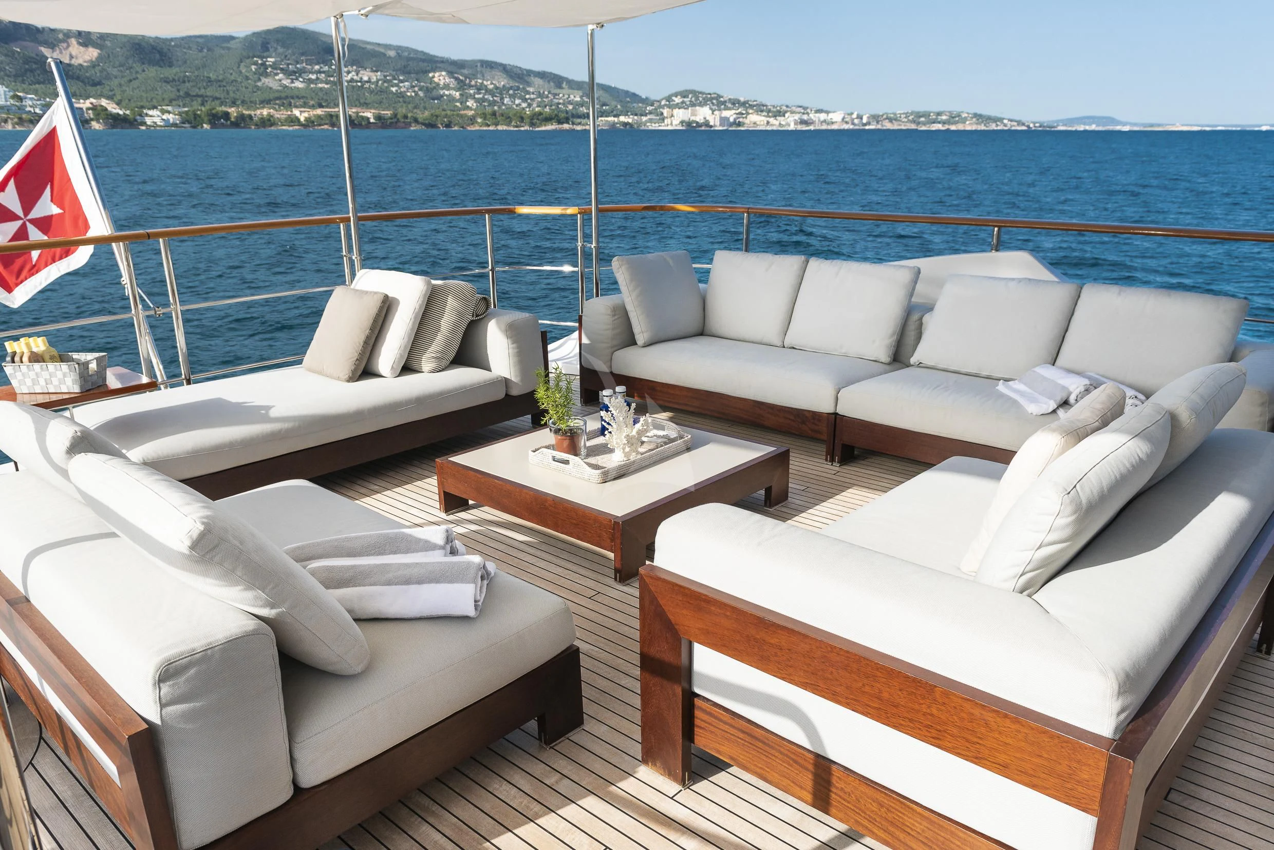 a room with couches and a flag aboard ORSO 3 Yacht for Sale