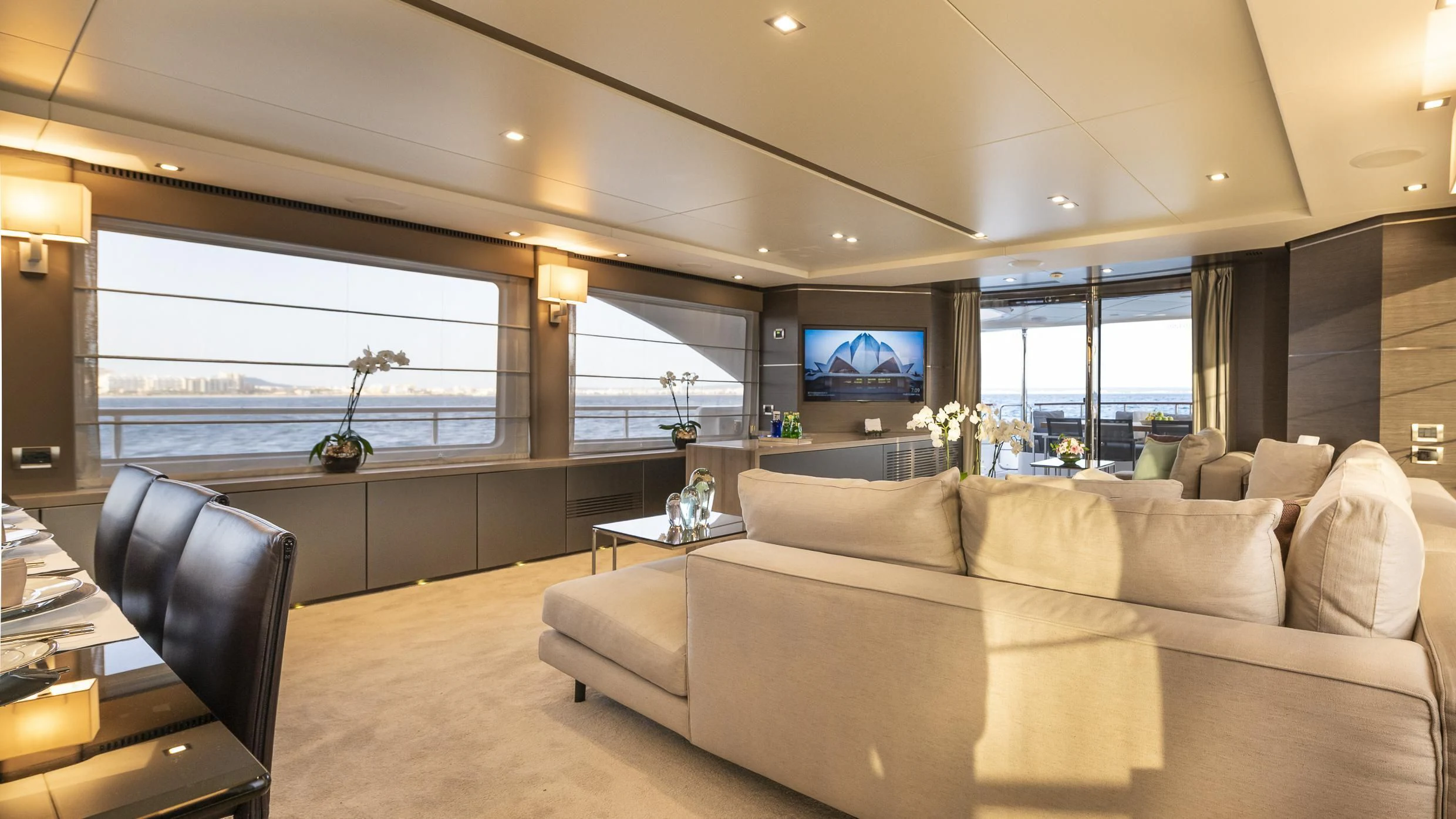 a living room with a large window aboard ORSO 3 Yacht for Sale