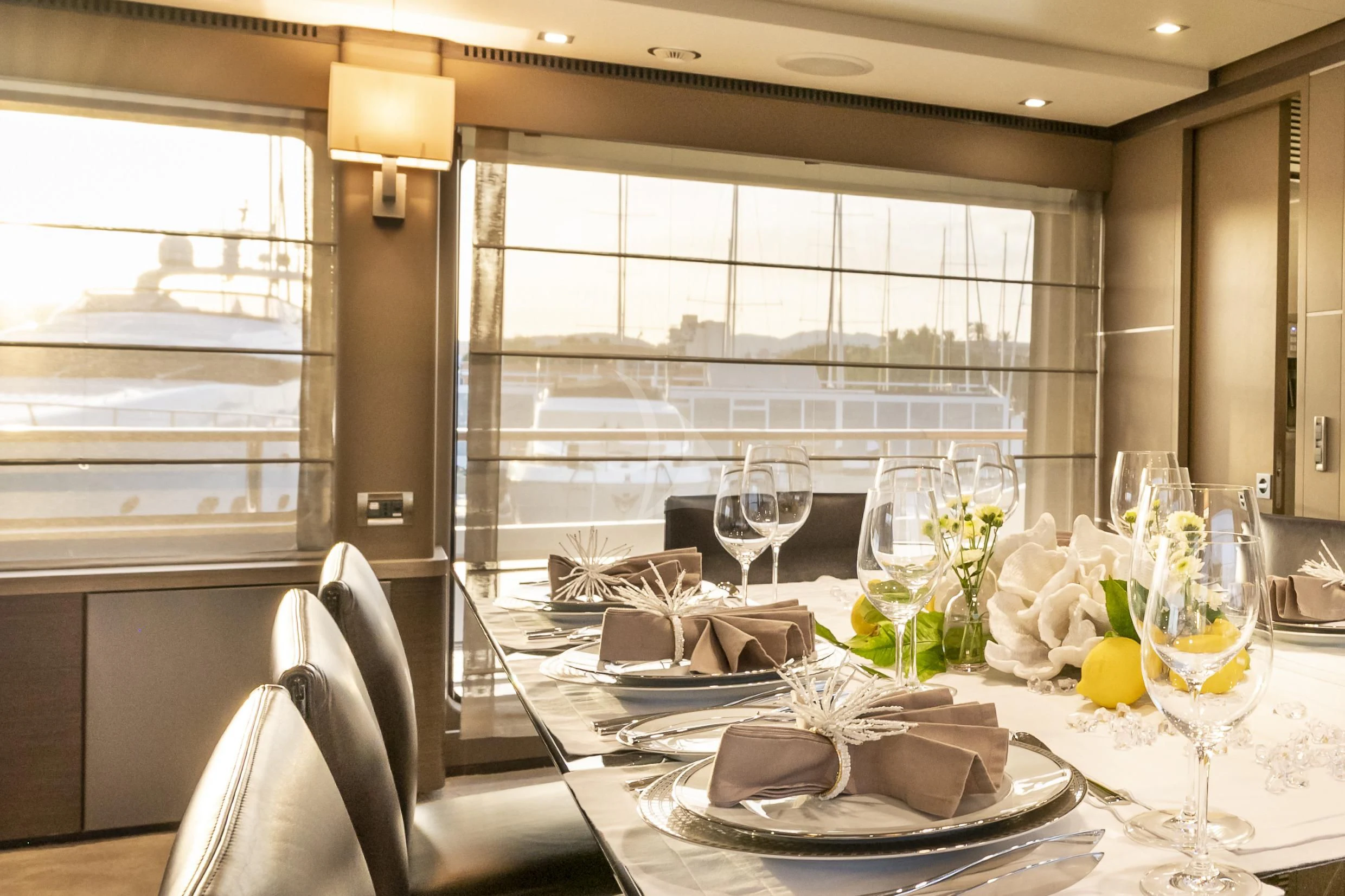 a table set with plates and glasses aboard ORSO 3 Yacht for Sale