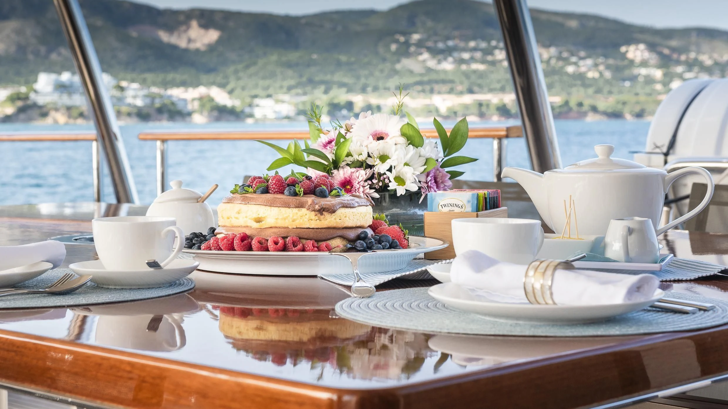 a table with a cake and fruit on it aboard ORSO 3 Yacht for Sale