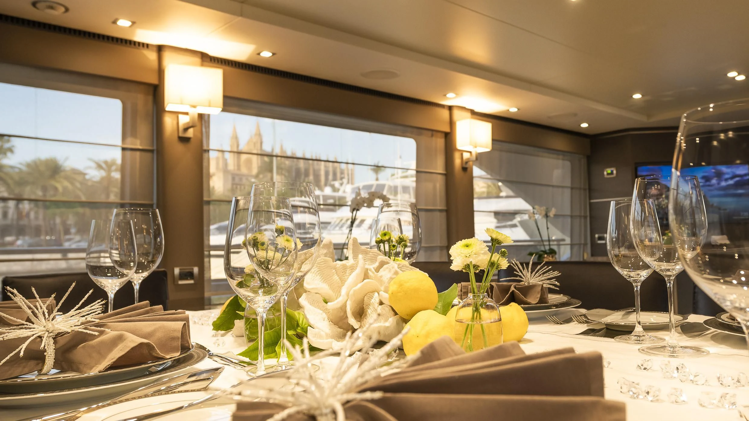 a table with glasses and flowers aboard ORSO 3 Yacht for Sale