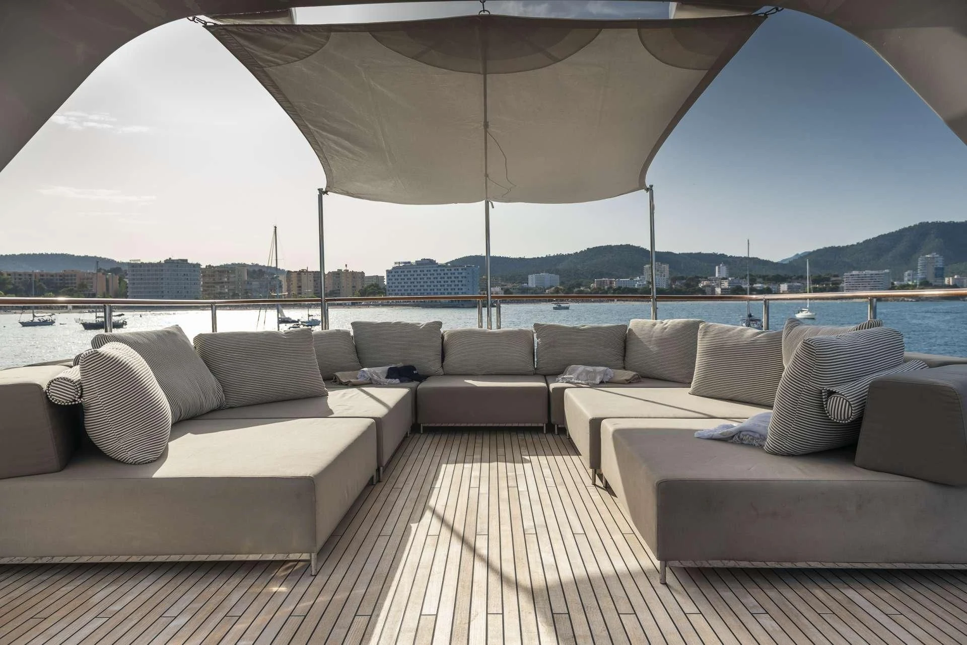 a large living room with a large white sofa and a large body of water aboard ORSO 3 Yacht for Sale