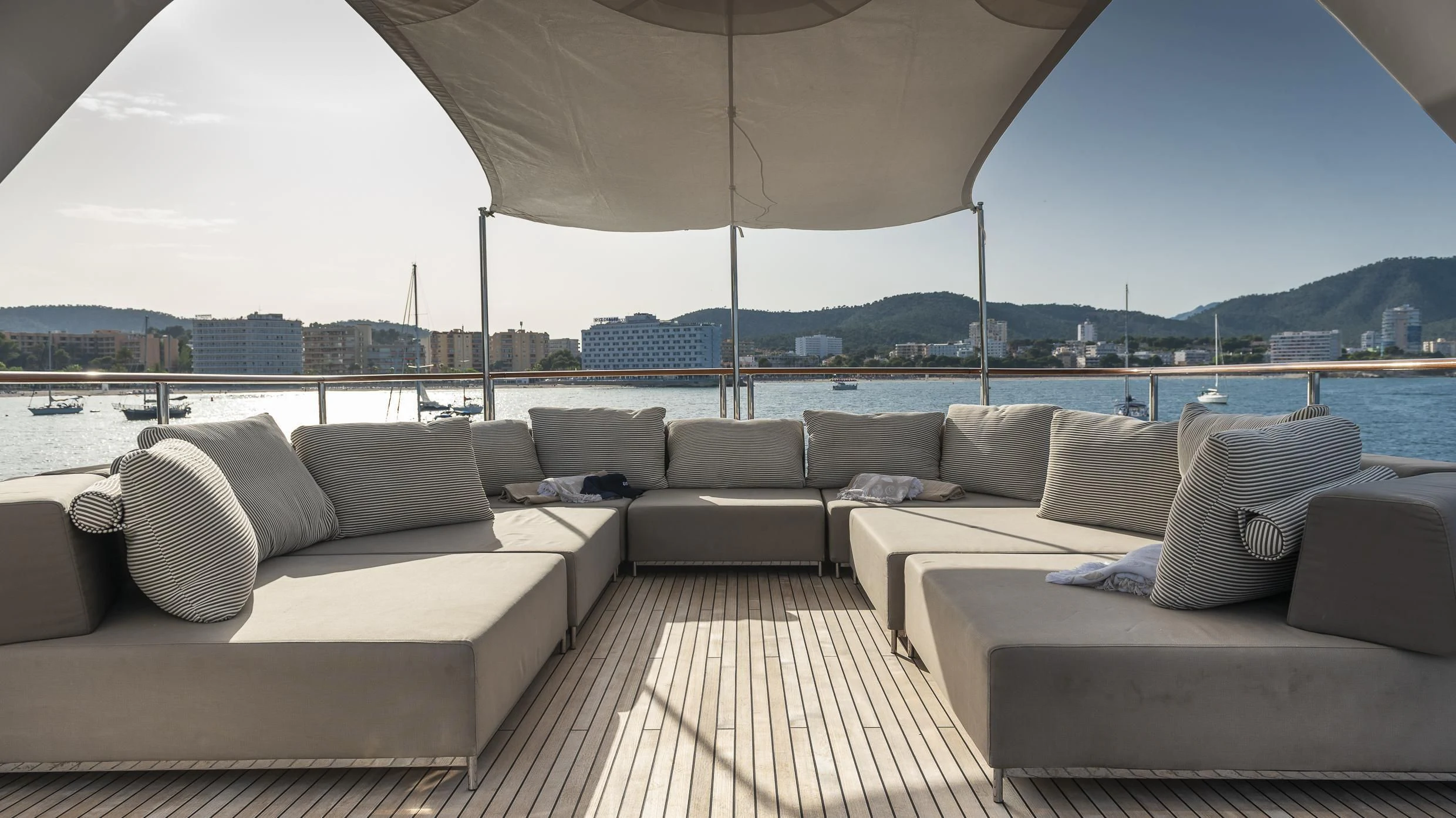 a large living room with a large white sofa and a large body of water aboard ORSO 3 Yacht for Sale