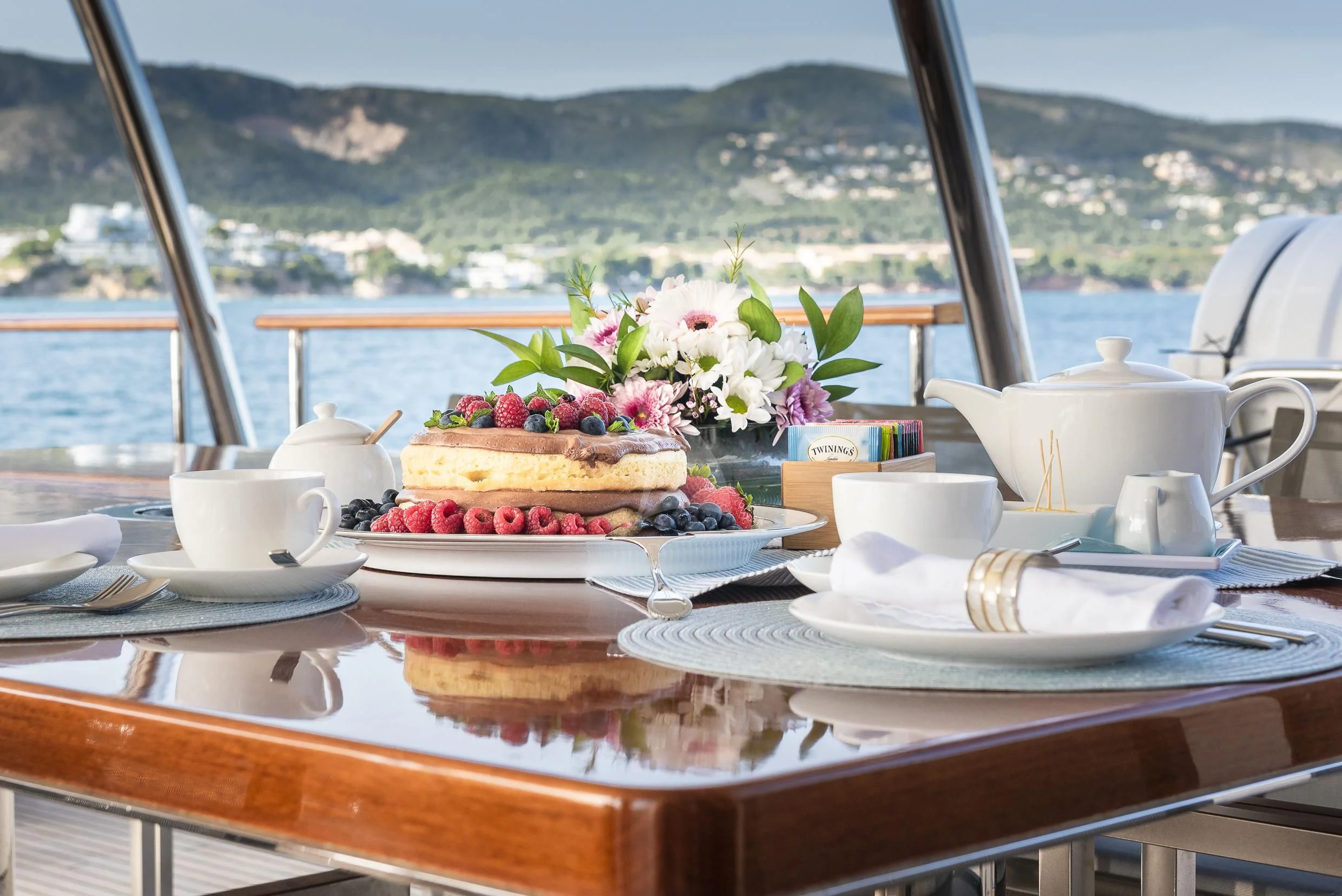a table with a cake and fruit on it aboard ORSO 3 Yacht for Sale