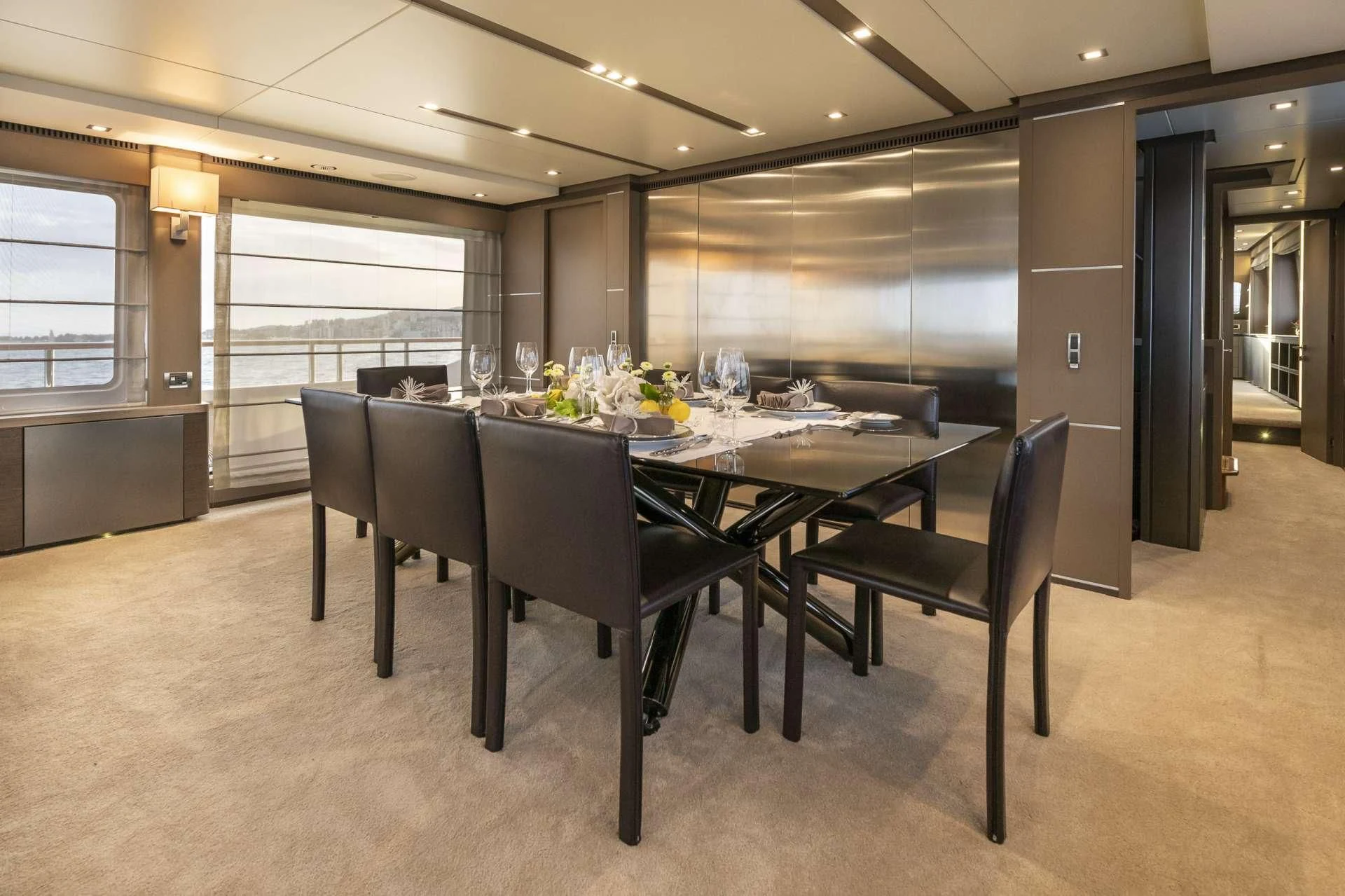 a large room with a table and chairs aboard ORSO 3 Yacht for Sale
