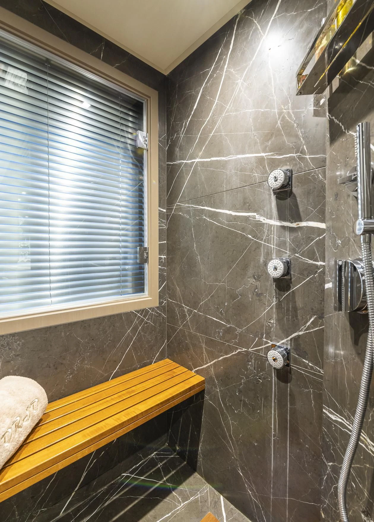 a shower with a tile wall aboard ORSO 3 Yacht for Sale