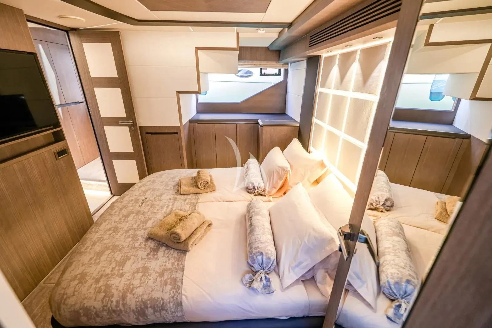 a bed with a white sheet and pillows aboard FG STAR Yacht for Charter