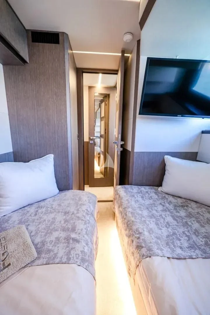 a room with a bed and a television aboard FG STAR Yacht for Charter