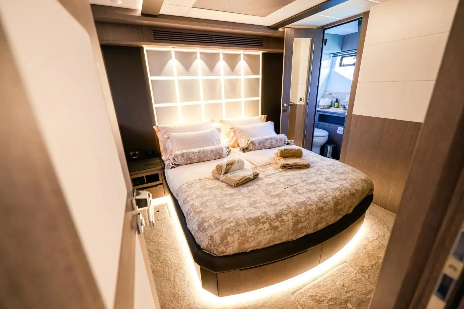 a bed with a white sheet aboard FG STAR Yacht for Charter