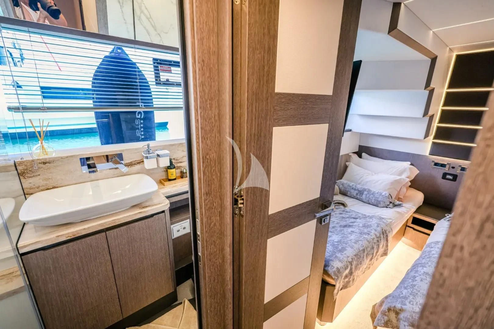 a small bedroom with a bed aboard FG STAR Yacht for Charter