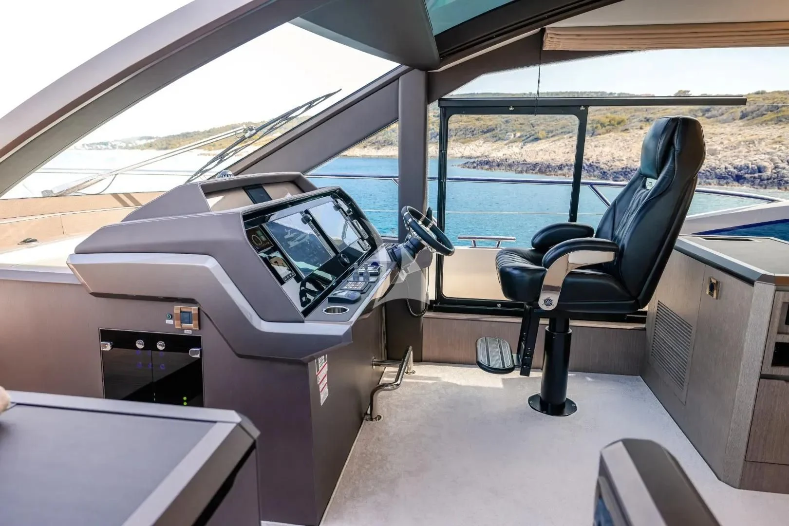 a car with a screen and a chair in the back aboard FG STAR Yacht for Charter