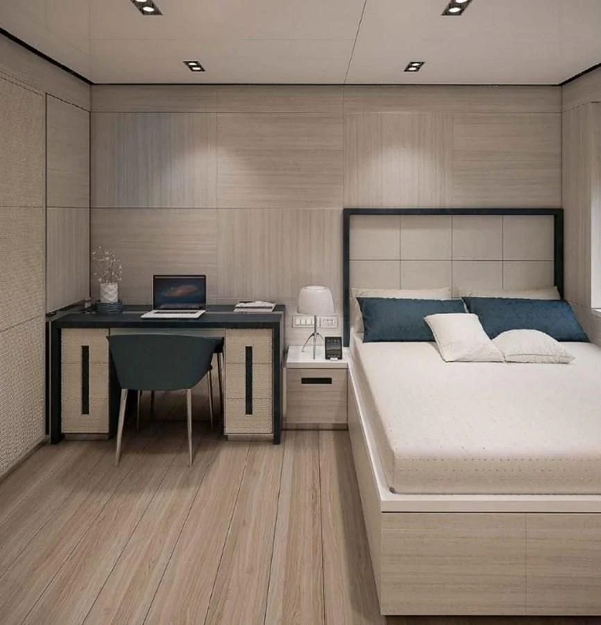 a bedroom with a desk and a bed aboard ICE 68 Yacht for Sale