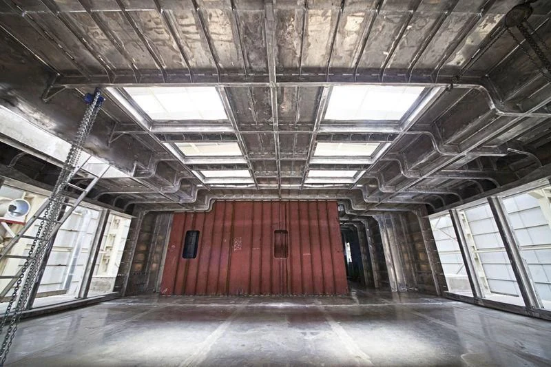 a large room with a red wall aboard ICE 68 Yacht for Sale