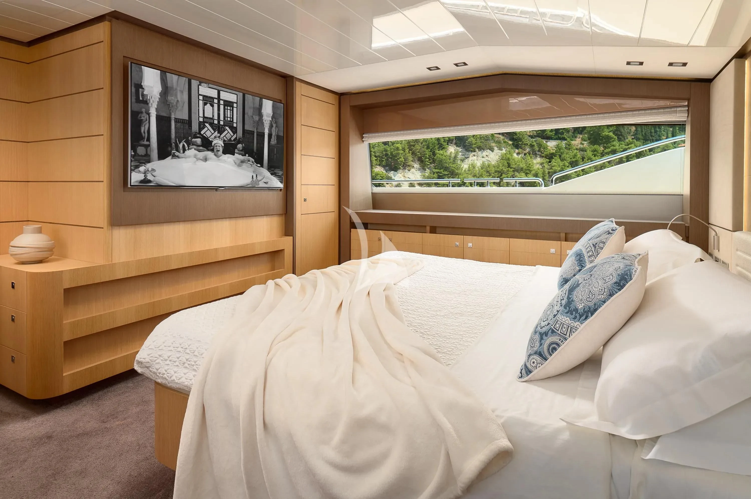 a bed with white sheets aboard IVA Yacht for Sale