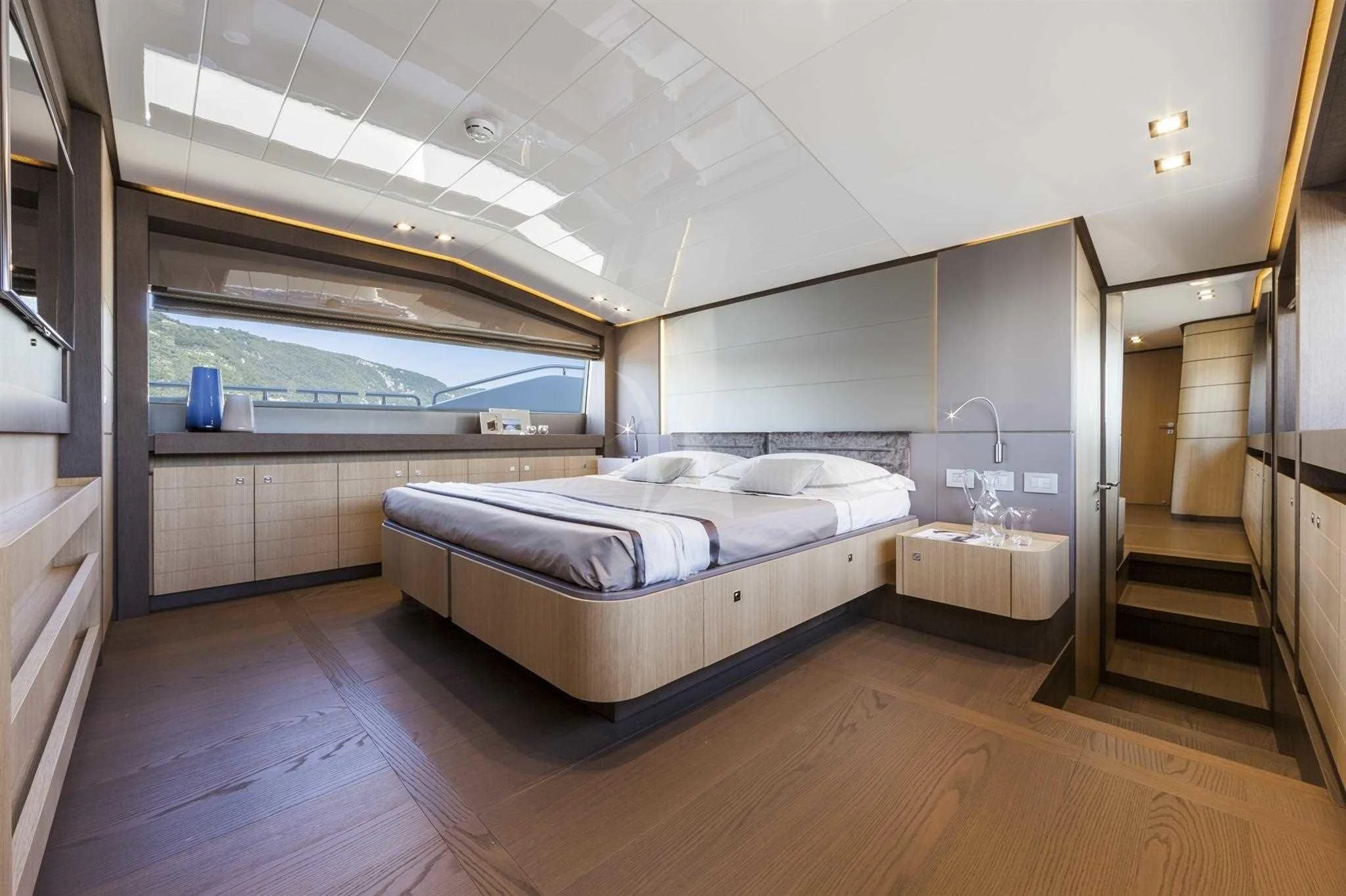a large bedroom with a large glass window aboard IVA Yacht for Sale