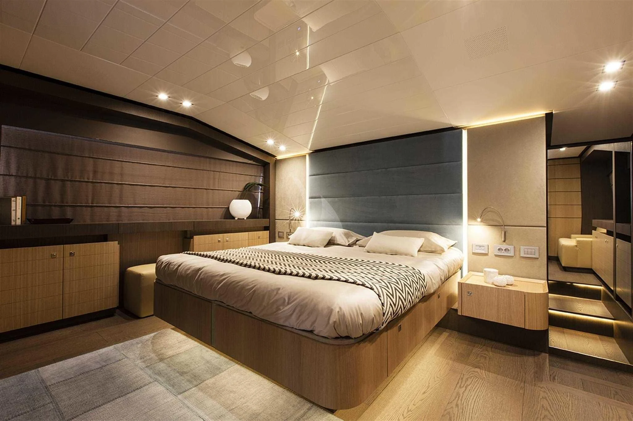 a large bedroom with a large bed aboard IVA Yacht for Sale
