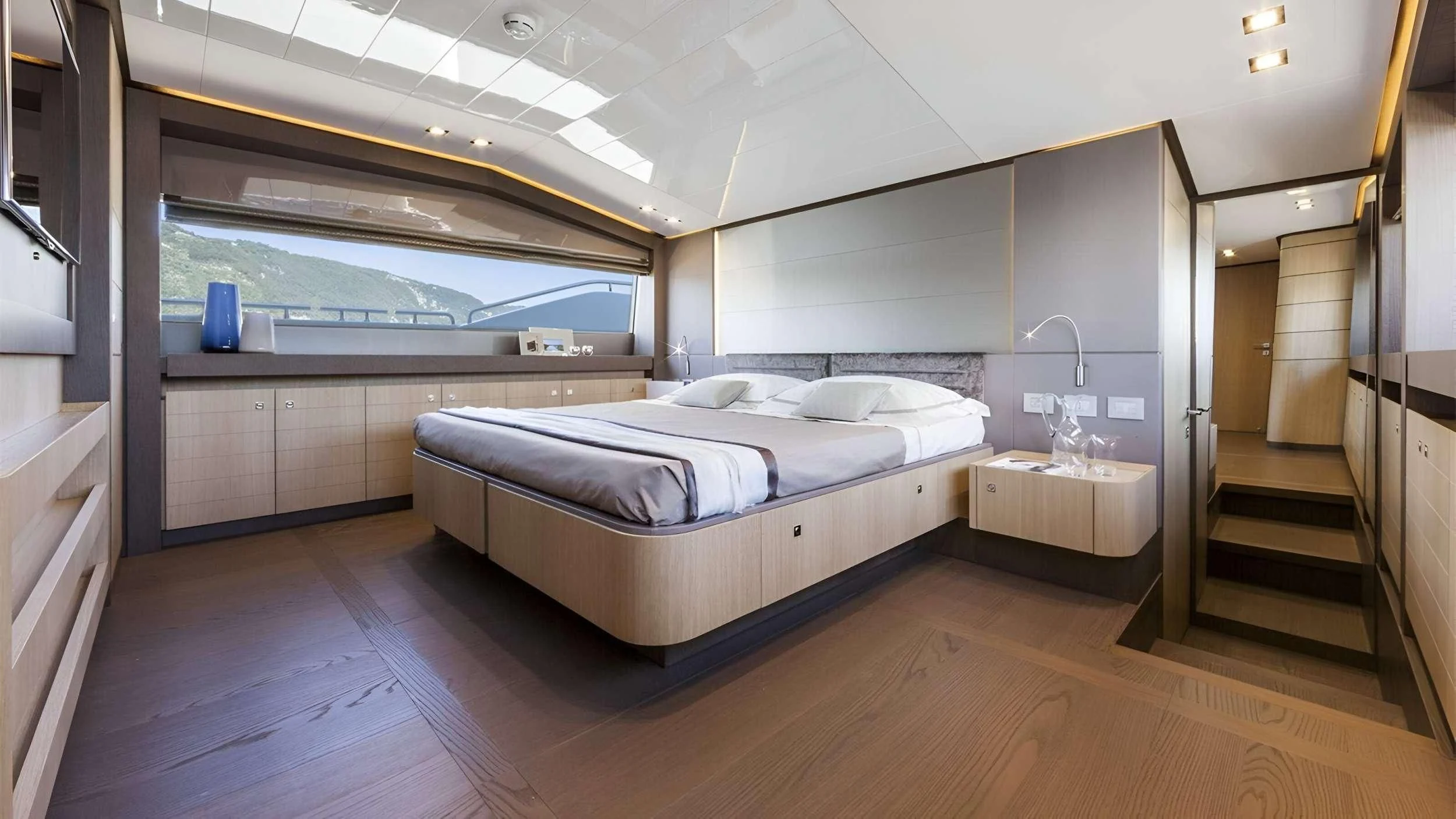 a large bedroom with a large glass window aboard IVA Yacht for Sale