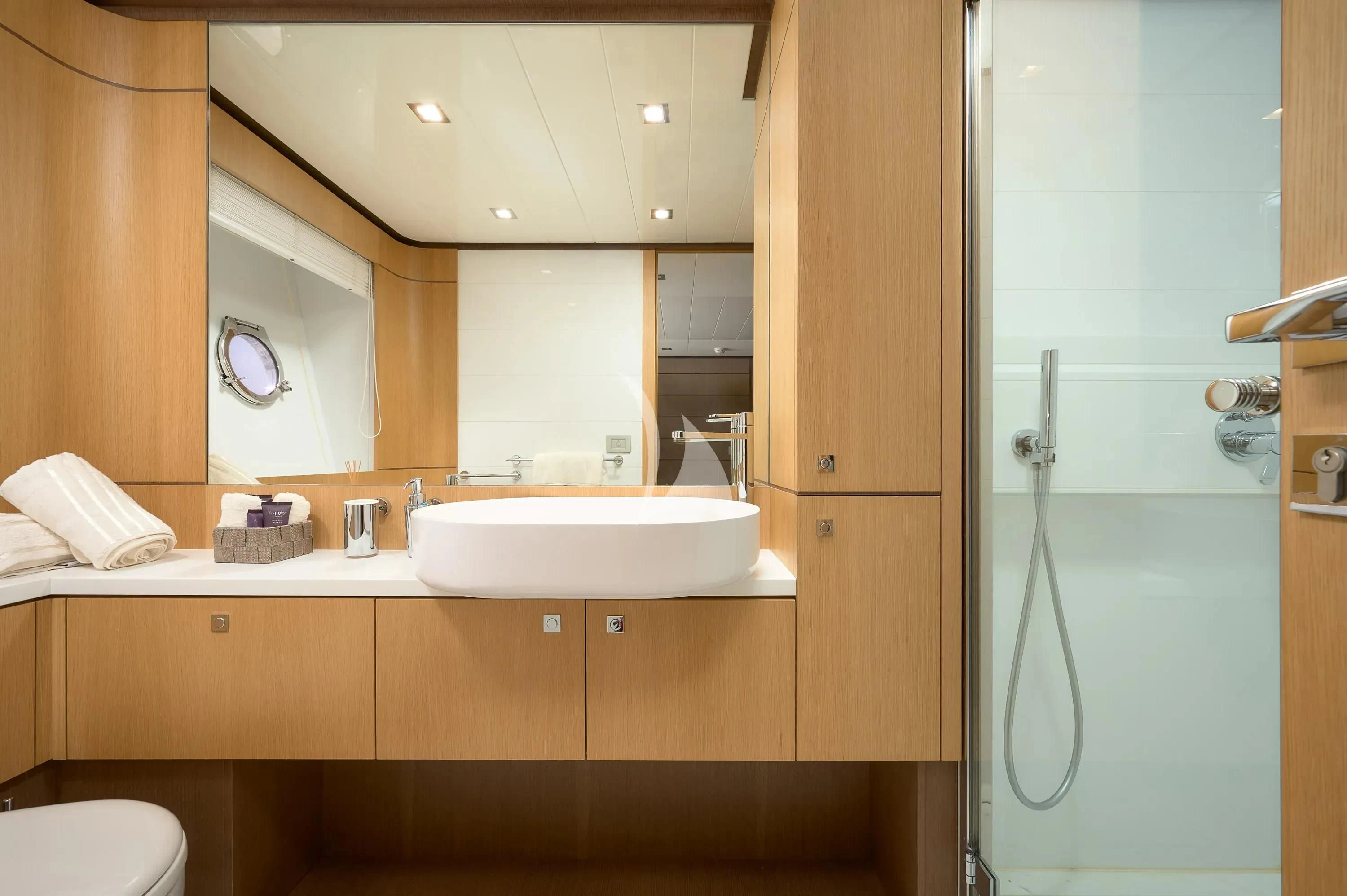 a bathroom with a sink and mirror aboard IVA Yacht for Sale