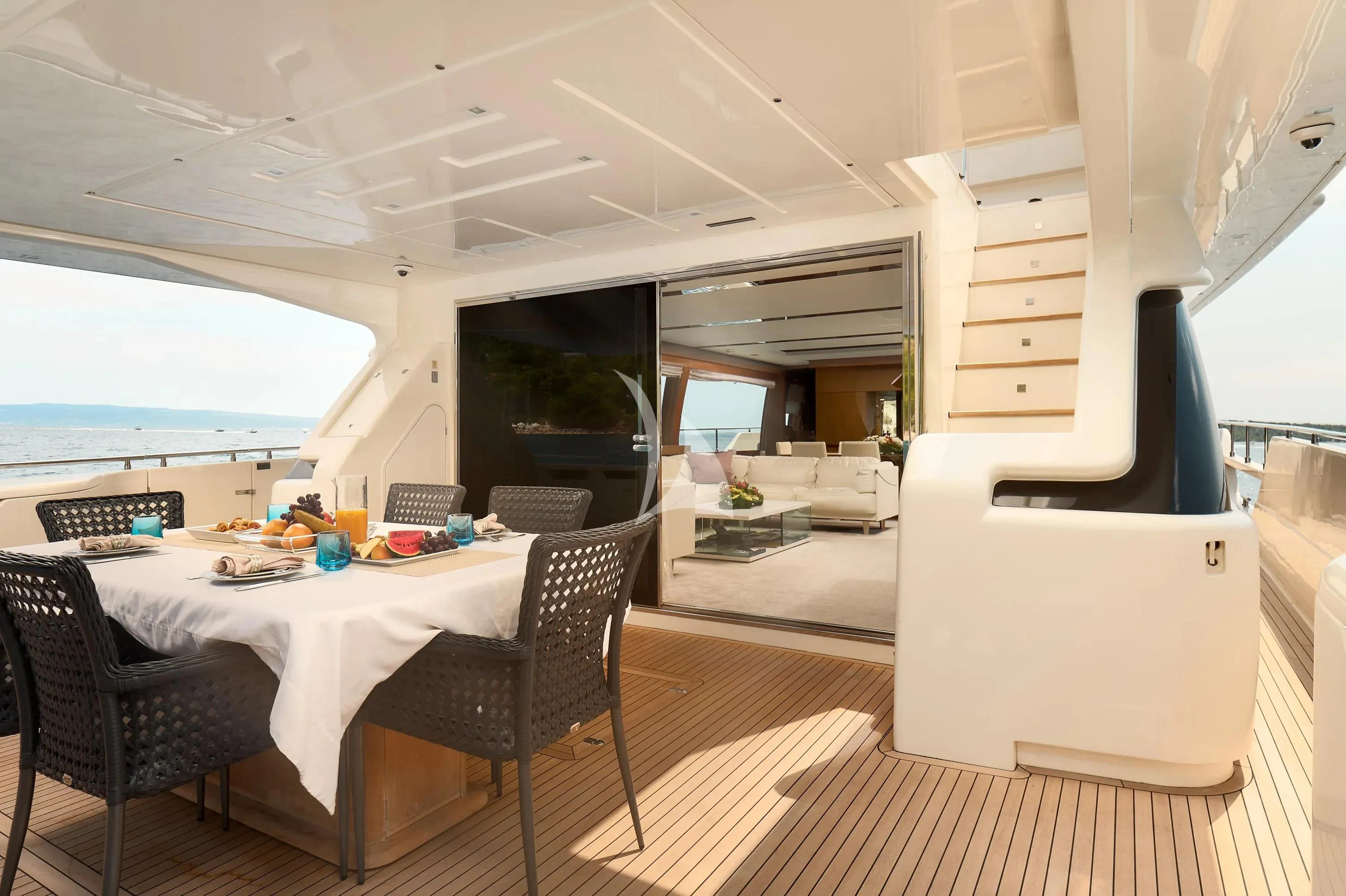 a room with a table and chairs aboard IVA Yacht for Sale