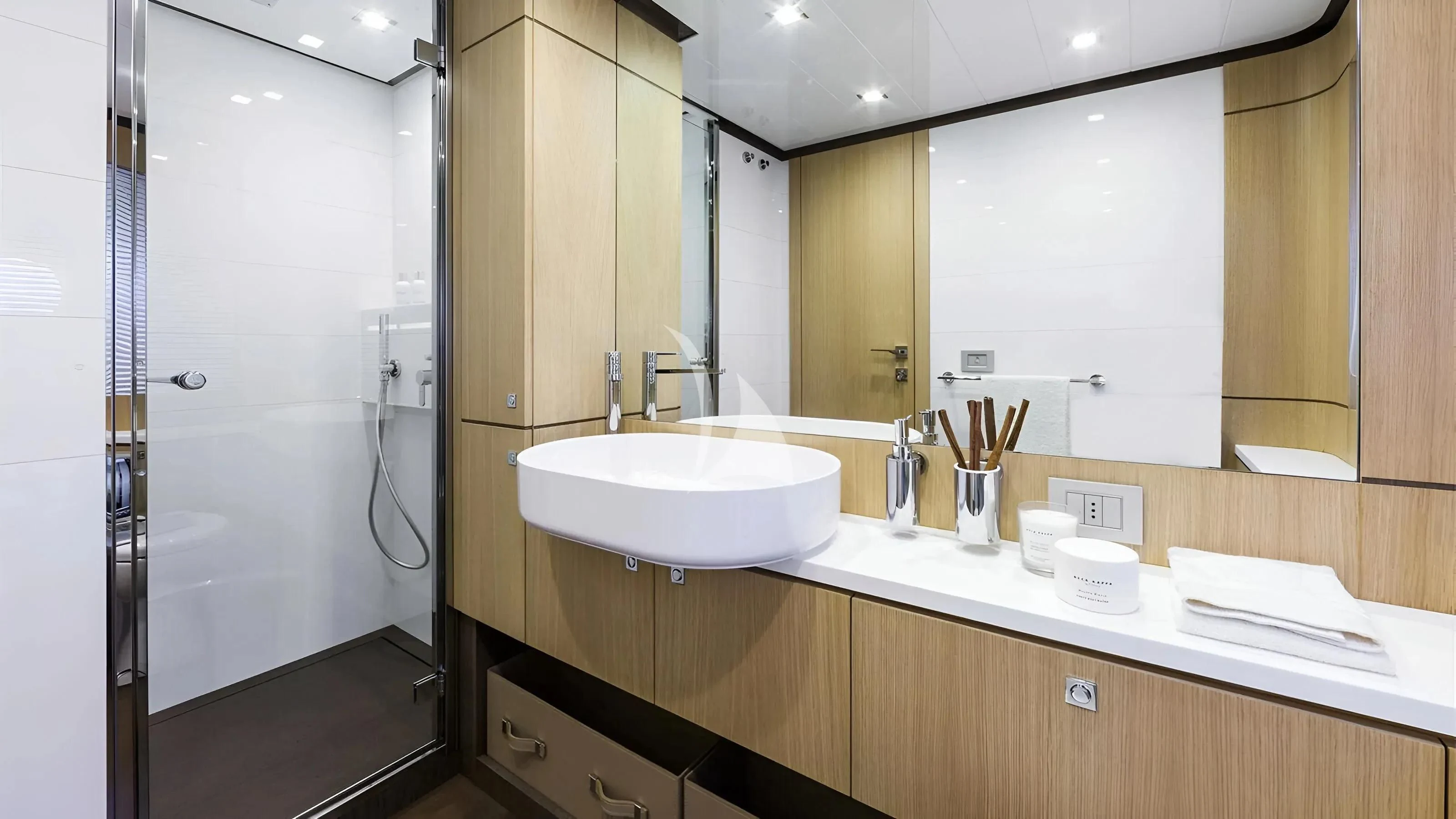 a bathroom with a sink and mirror aboard IVA Yacht for Sale