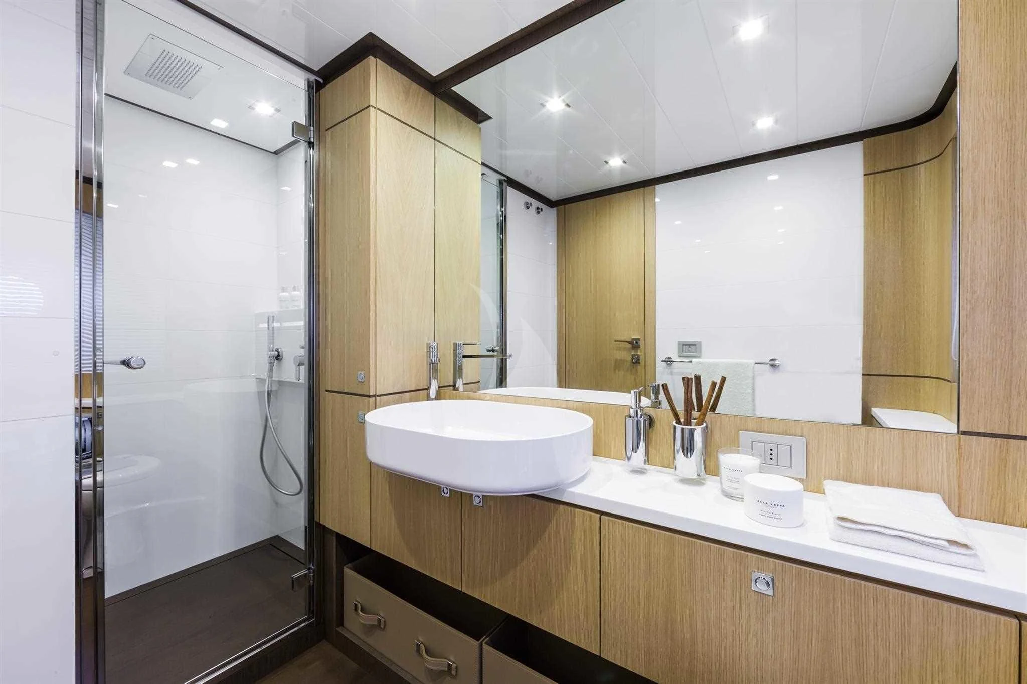 a bathroom with a sink and mirror aboard IVA Yacht for Sale