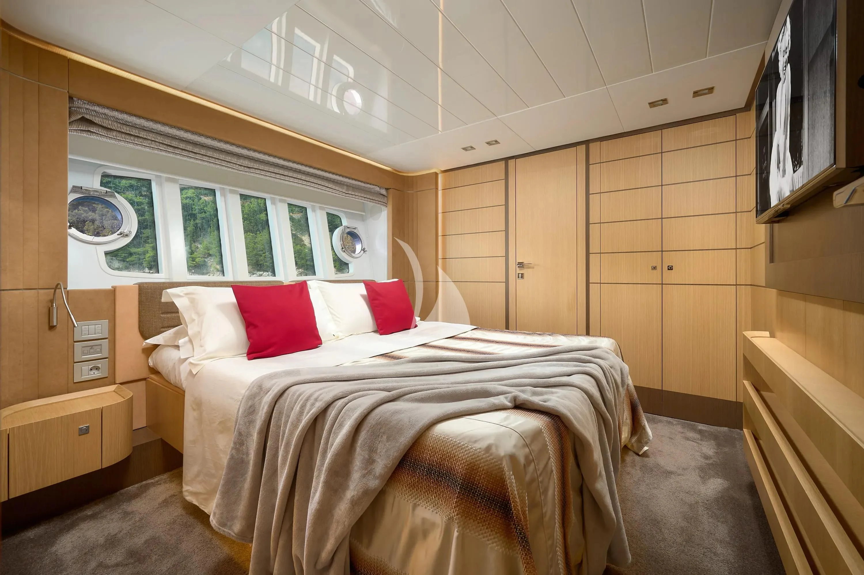 a bedroom with a bed and a window aboard IVA Yacht for Sale