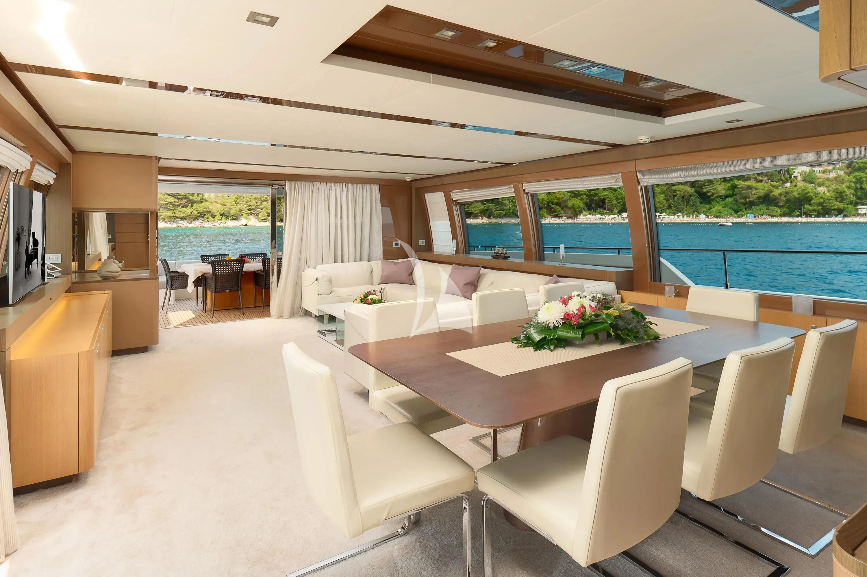 a room with a table chairs and a large window aboard IVA Yacht for Sale