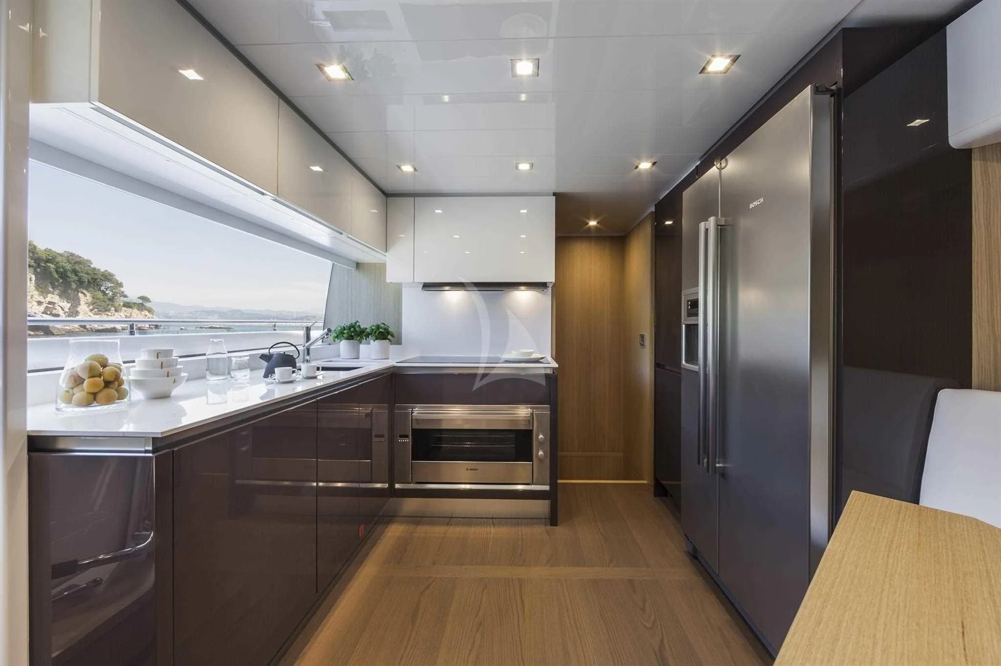 a kitchen with a large refrigerator aboard IVA Yacht for Sale