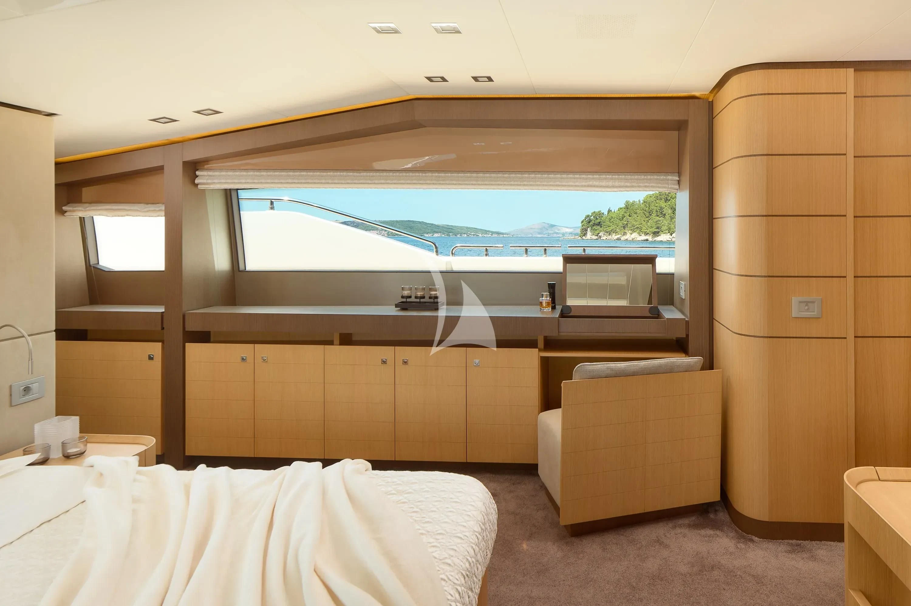 a room with a bed and a large window aboard IVA Yacht for Sale