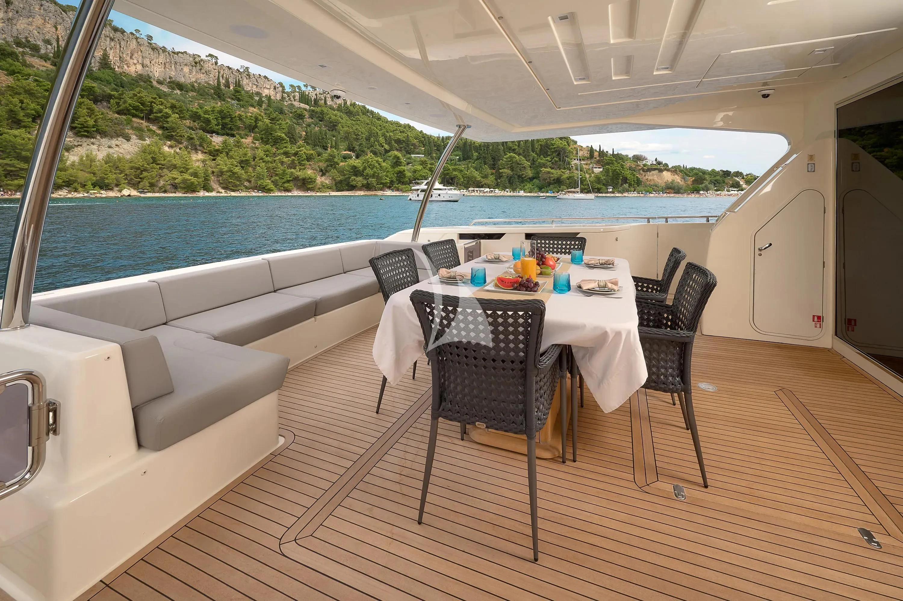 a table and chairs on a deck aboard IVA Yacht for Sale