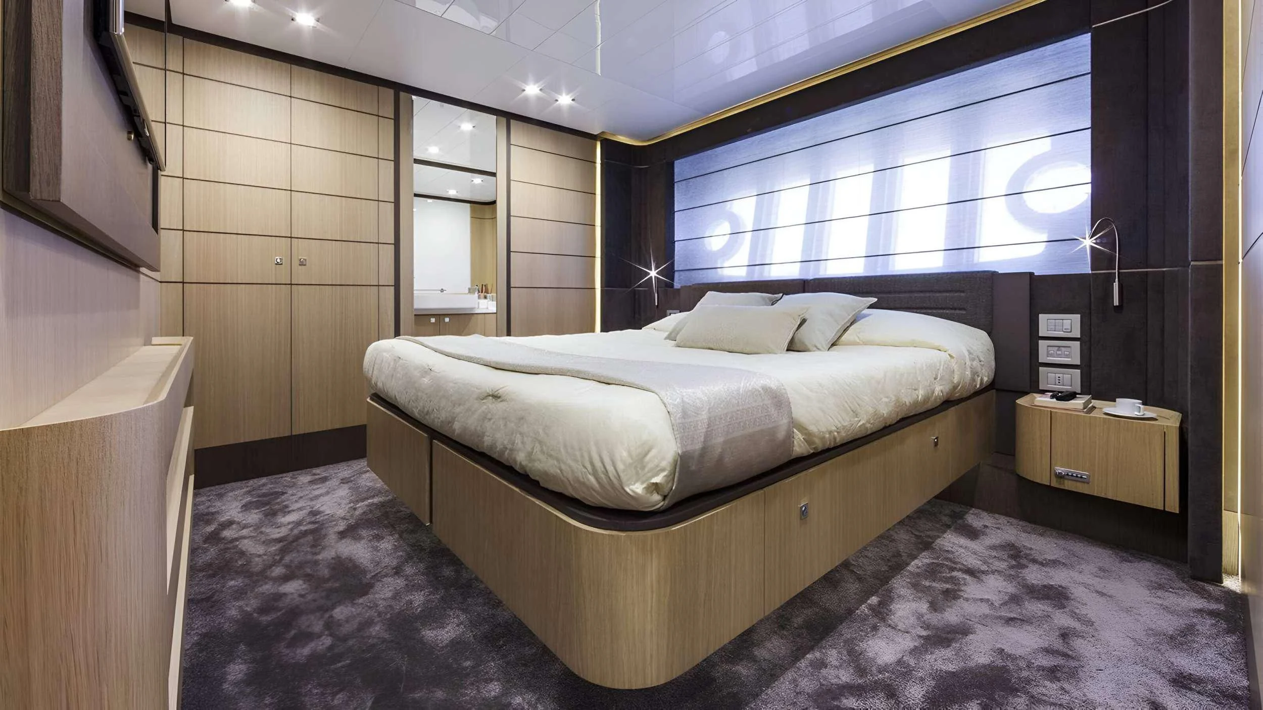 a room with a bed and a window aboard IVA Yacht for Sale