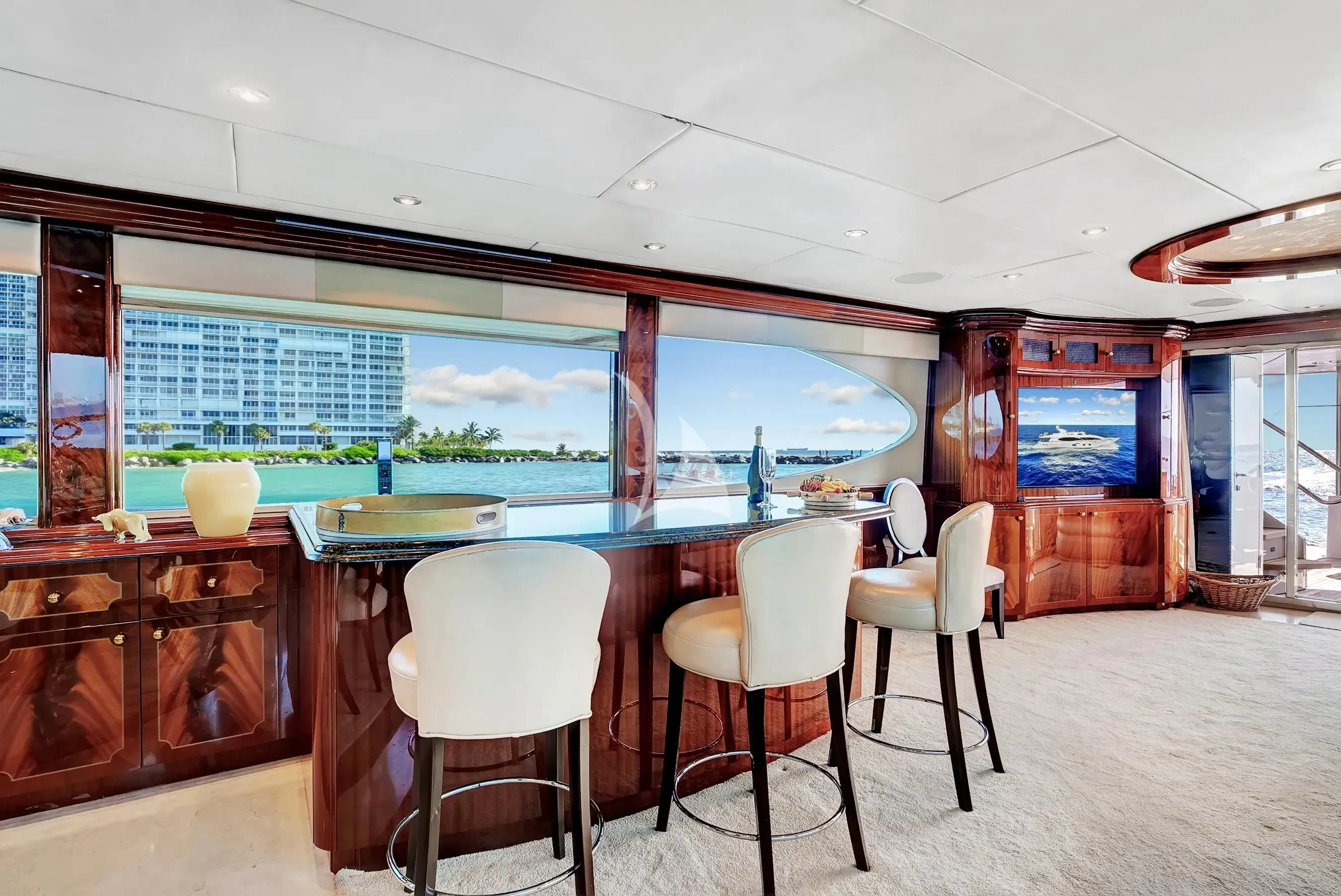 a room with a table and chairs aboard LE REVE Yacht for Sale