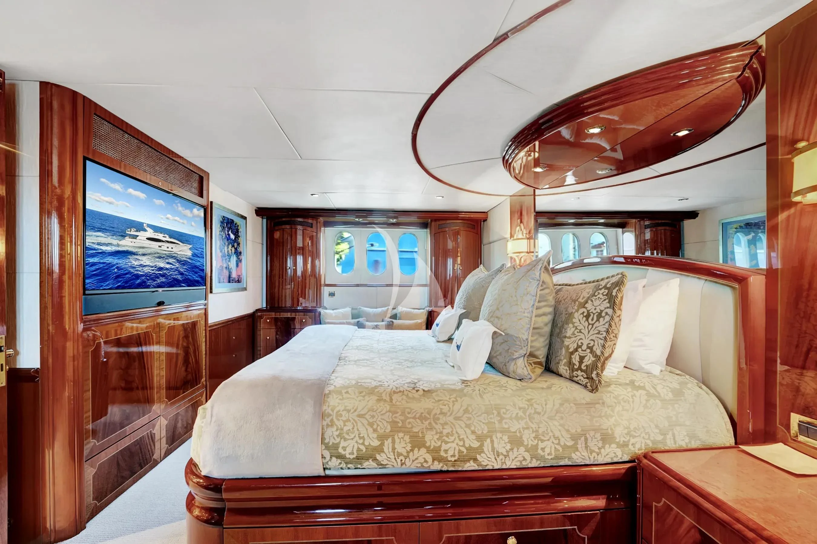a bedroom with a bed and a television aboard LE REVE Yacht for Sale