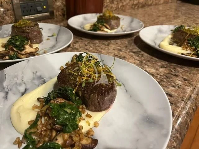 a table with plates of food aboard LE REVE Yacht for Sale