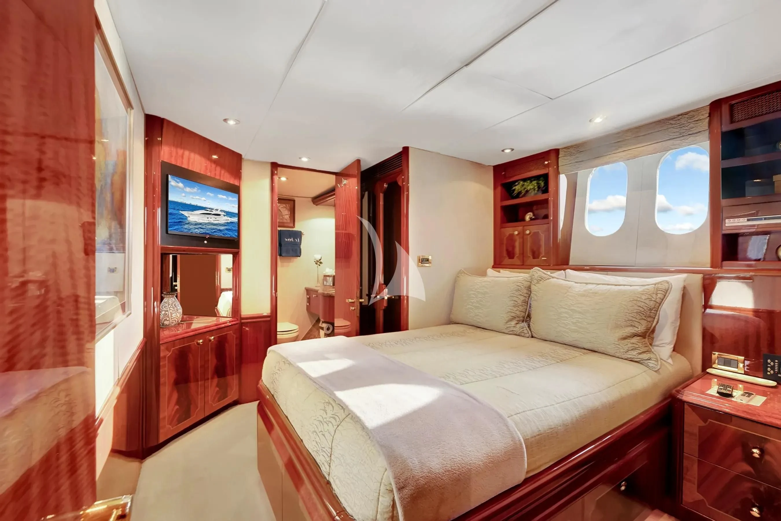 a bedroom with a bed and a tv on the wall aboard LE REVE Yacht for Sale