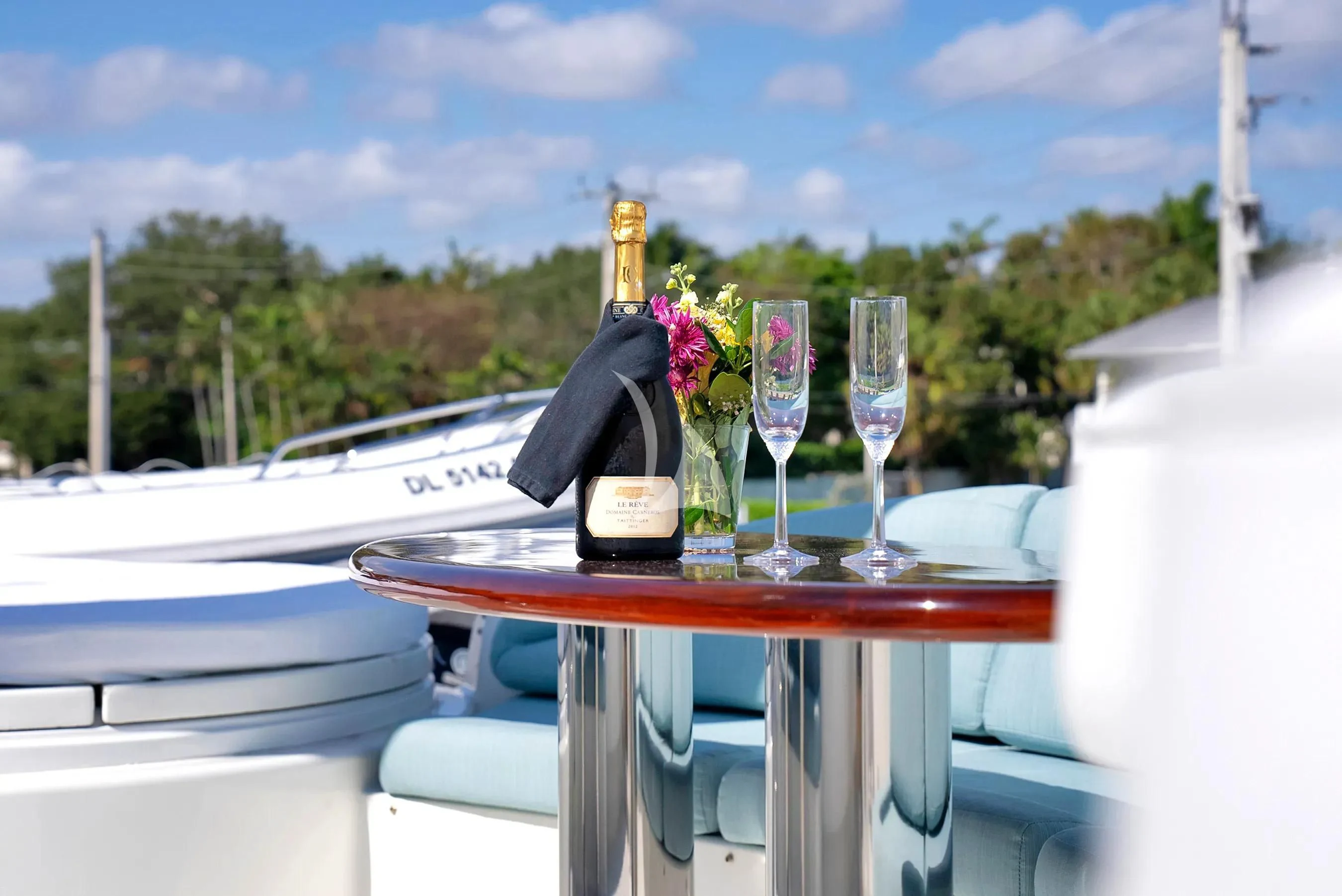 a table with wine glasses and bottles on it aboard LE REVE Yacht for Sale