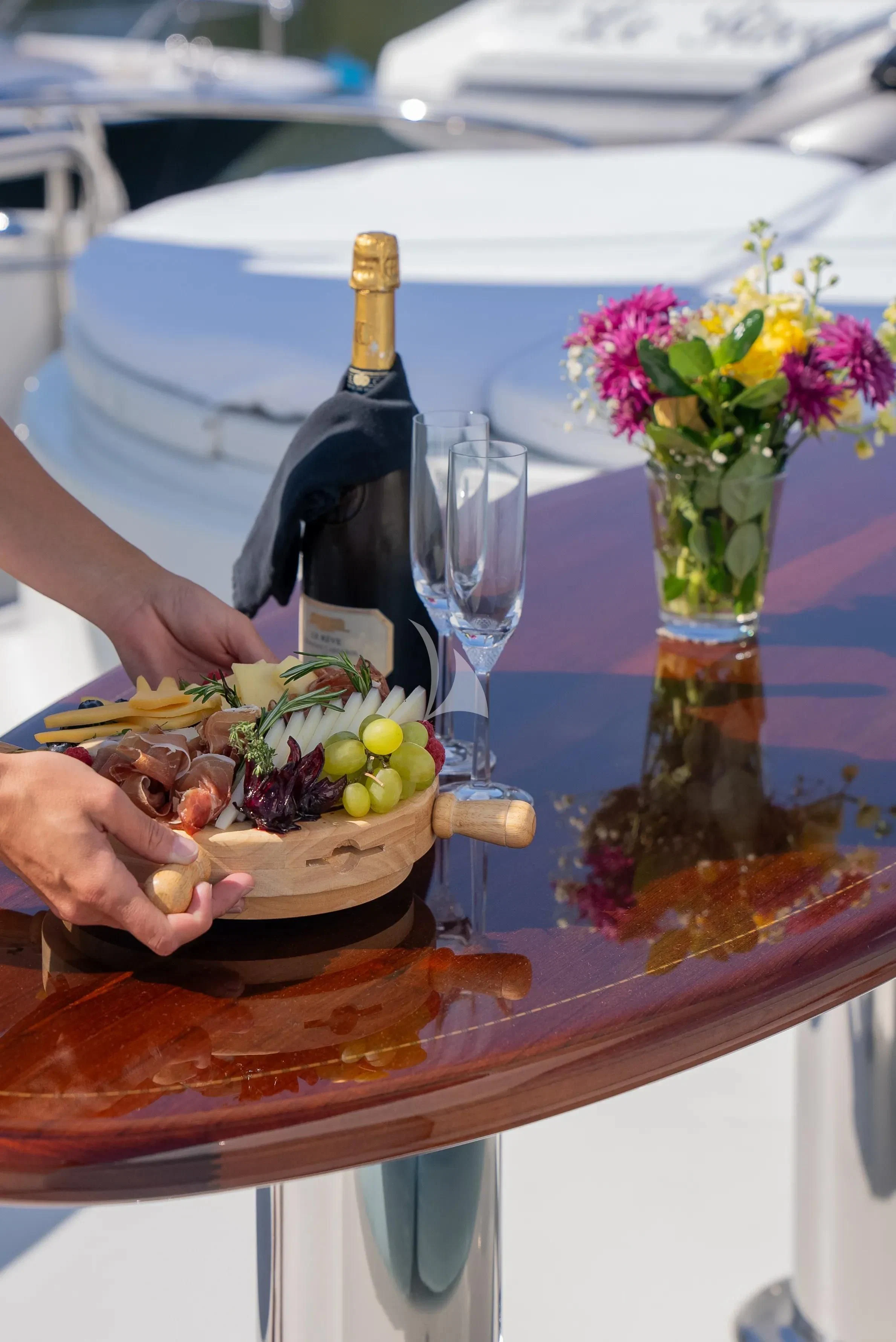 a bottle of wine on a table aboard LE REVE Yacht for Sale