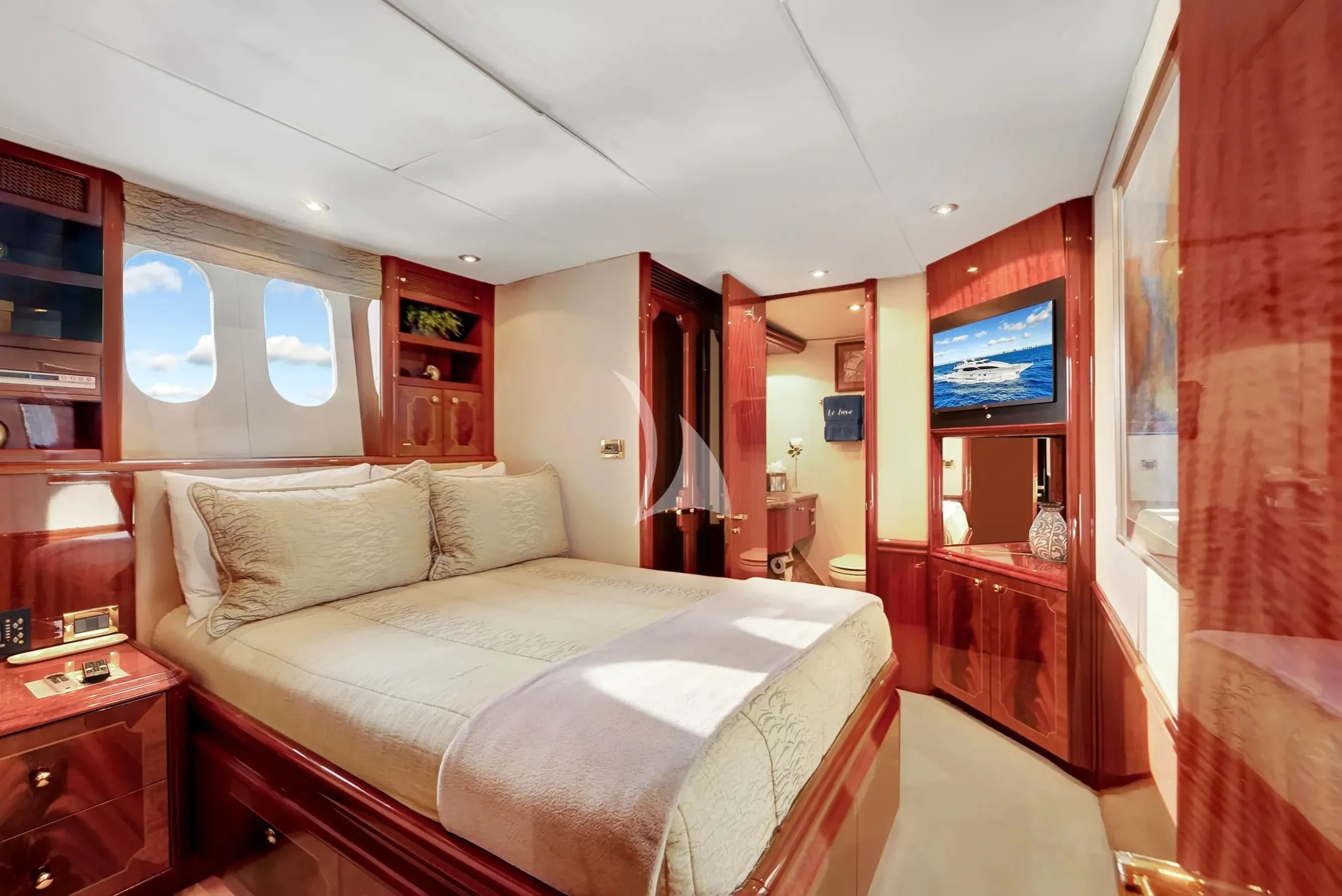 a bedroom with a bed and a tv on the wall aboard LE REVE Yacht for Sale