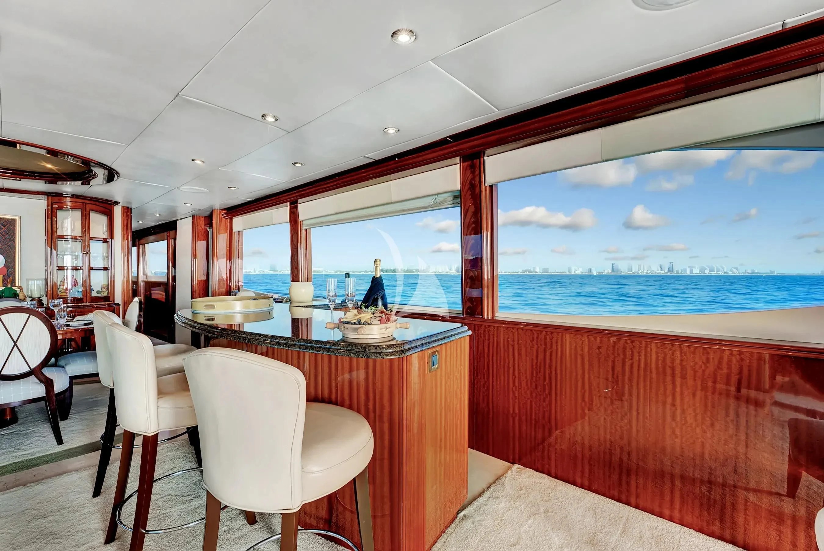 a room with a table and chairs aboard LE REVE Yacht for Sale