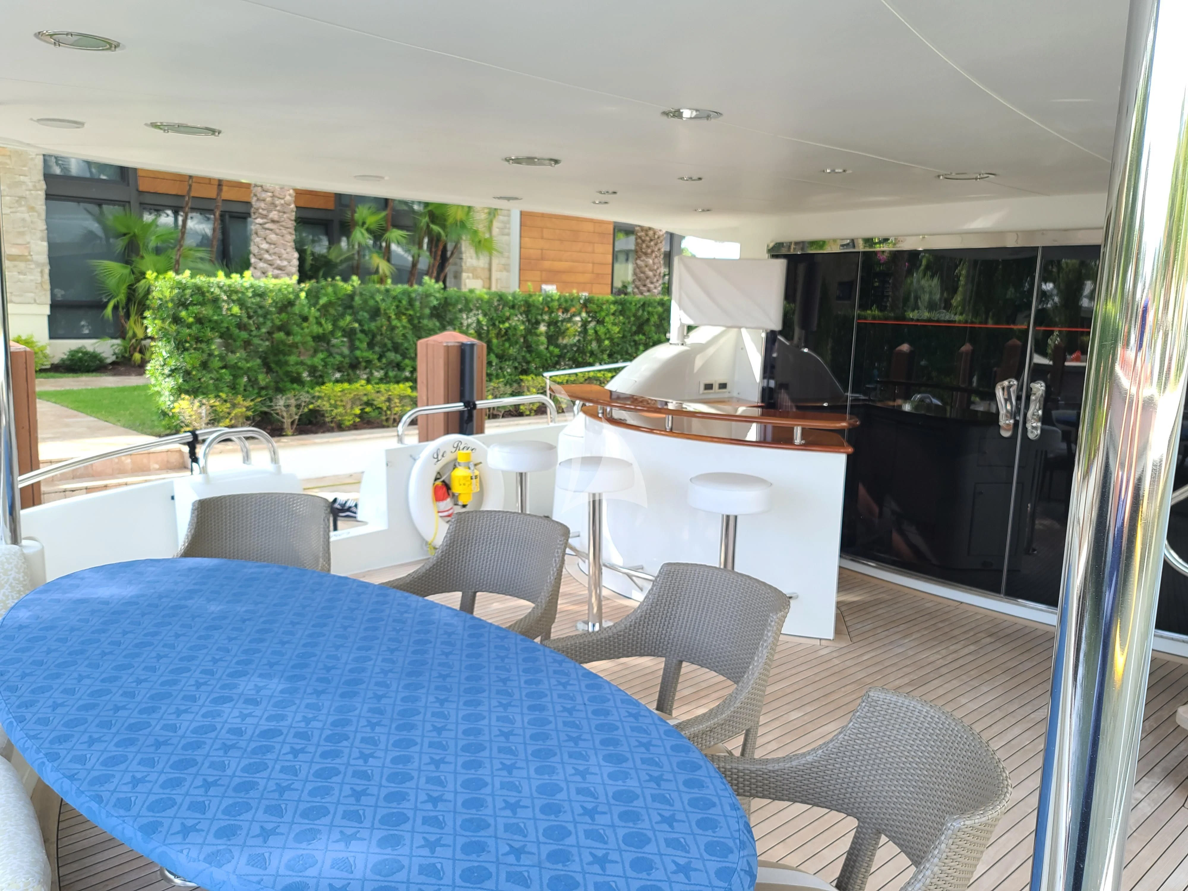 a table and chairs in a room aboard LE REVE Yacht for Sale