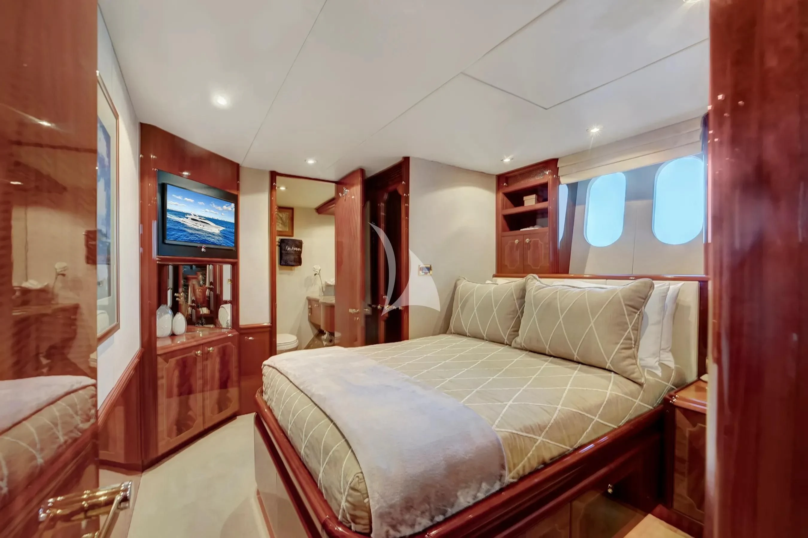 a bedroom with a bed and a television aboard LE REVE Yacht for Sale