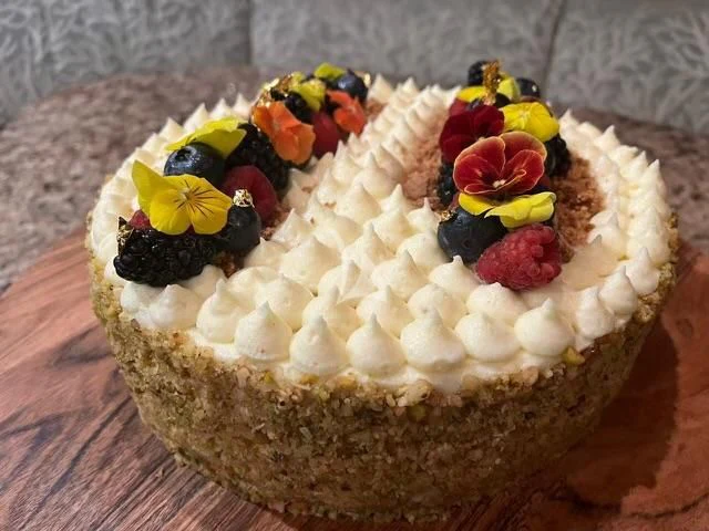 a cake with white frosting and fruit on top aboard LE REVE Yacht for Sale